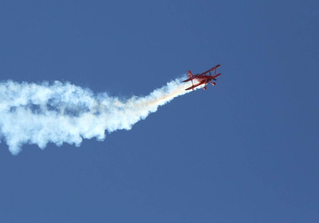 The “Oracle Challenger,” piloted by Sean D. Tucker, dives through the air during the 2014 Miramar Air Show aboard Marine Corps Air Station Miramar, Calif., Oct. 4. Tucker took his aircraft to its limits performing daring stunts, dives and rolls for the crowd. (Official Marine Corps Photo by Cpl. Raquel Barraza/released)
