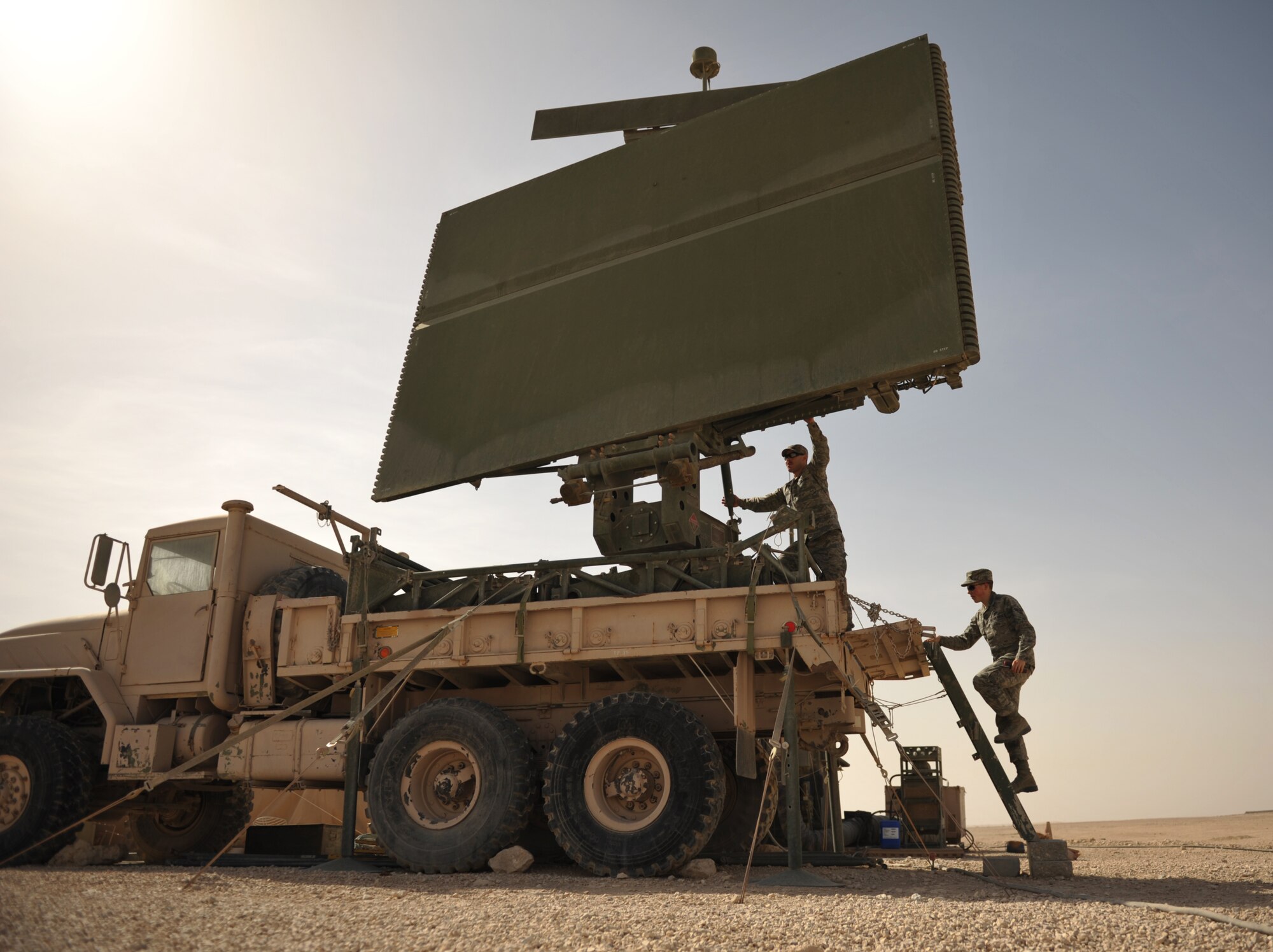 Senior Airman Joseph Fletcher and Airman 1st Class Christopher Kelly inspect a TPS-75 radar March 13, 2012, in Southwest Asia. The radar site contributes to the overall picture that the operators see inside an operations center. Fletcher and Kelly are radar maintenance technicians with the 71st Expeditionary Air Control Squadron. (U.S. Air Force photo/Staff Sgt. Nathanael Callon)