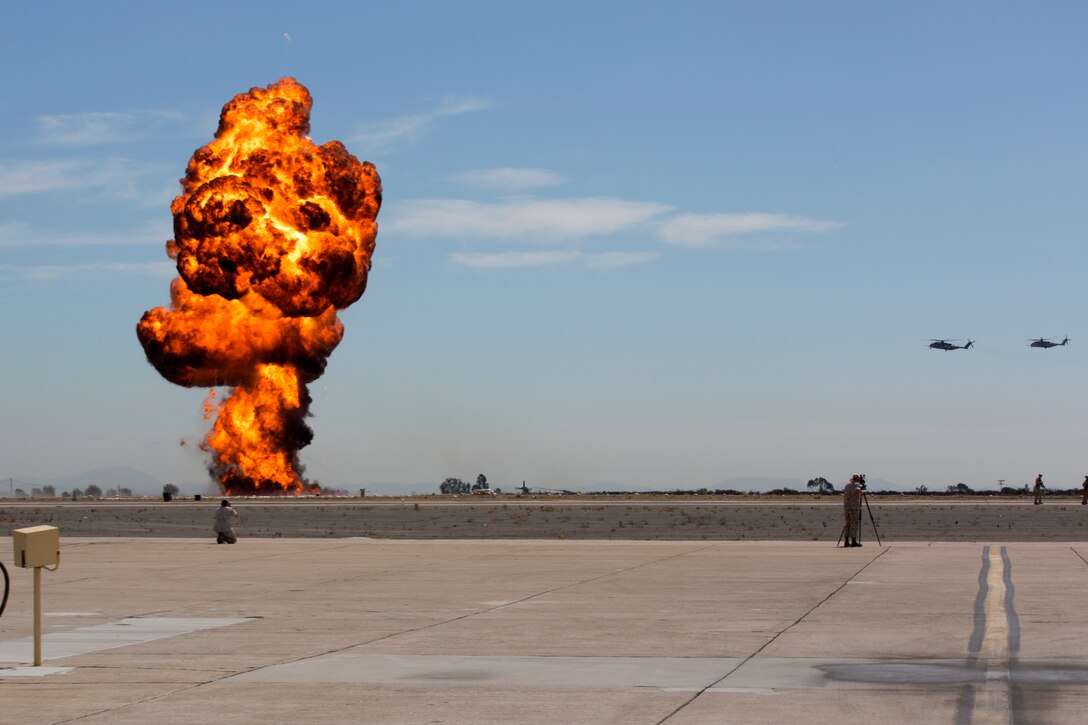 A simulated explosion rocks the flight line during the Marine Air-Ground Task Force demonstration portion of the 2014 Miramar Air Show aboard Marine Corps Air Station Miramar, Calif., Oct. 3. Explosions helped crowds understand a very real aspect of the power the MAGTF commander has at his or her disposal in order to accomplish missions all over the globe.