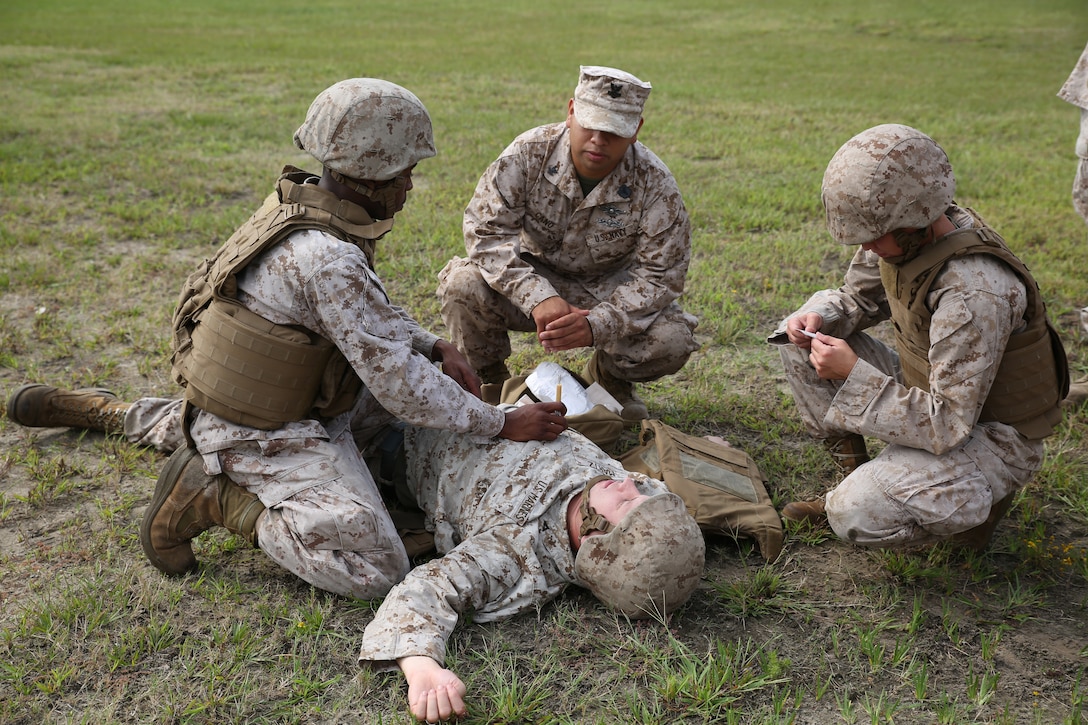 Marines with the Ground Combat Element Integrated Task Force conduct simulated care under fire as part of an evaluation during combat lifesaver course at the task force barracks at Marine Corps Base Camp Lejeune, North Carolina, Oct. 3, 2014. Marines simulated carrying a casualty to a safe area and applying first aid. From October 2014 to July 2015, the GCEITF will conduct individual and collective level skills training in designated ground combat arms occupational specialties in order to facilitate the standards based assessment of the physical performance of Marines in a simulated operating environment performing specific ground combat arms tasks. (U.S. Marine Corps photo by Cpl. Paul S. Martinez/Released)