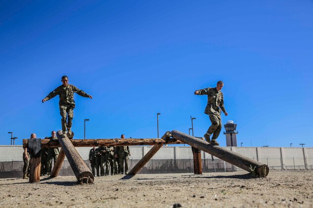 Company M recruits, 3rd Recruit Training Battalion, cross the Log Walk while running the Confidence Course at Marine Corps Recruit
Depot San Diego, Sept. 29. If the recruits fall or stop during their attempt to cross the obstacle, they must begin again.
