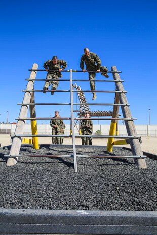 Company M recruits assend the Reverse Climb obstacle while running the depot’s Confidence Course. Once to the top, they cross over and descend. Other obstacles on the Confidence Course included the Monkey Bridge, Skyscraper, Wall Climb, the Rope Jump and several others.