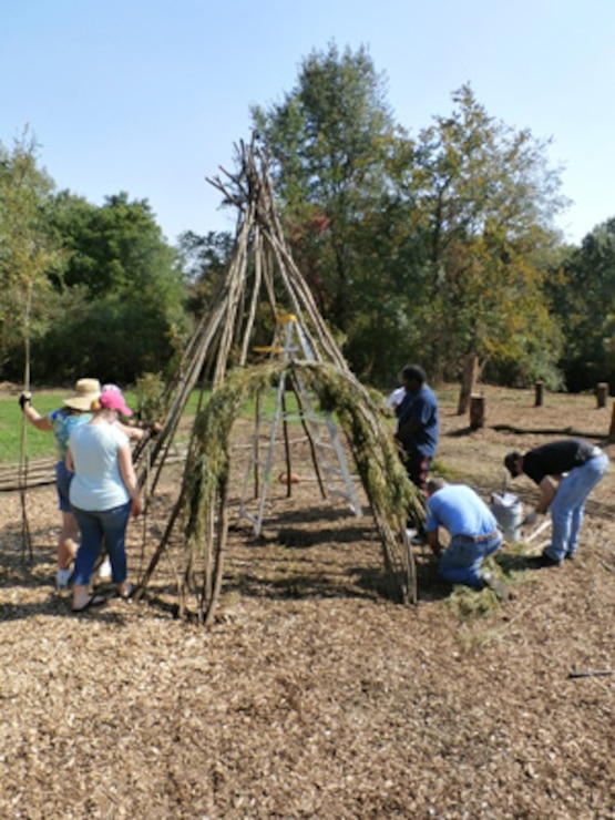 Willow artist and volunteers create structure for Playscape area        