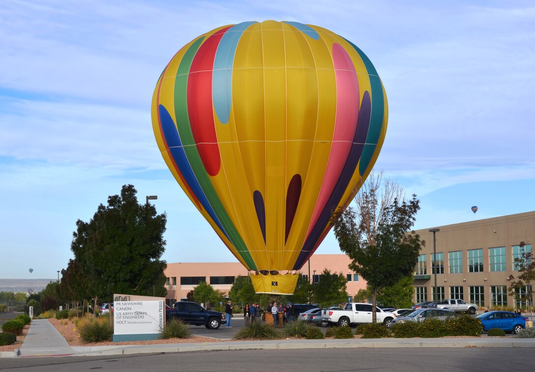 ALBUQUERQUE, N.M., -- During the Albuquerque International Balloon Fiesta a hot air balloon lands in the District Office's parking lot, Oct. 7, 2014. 