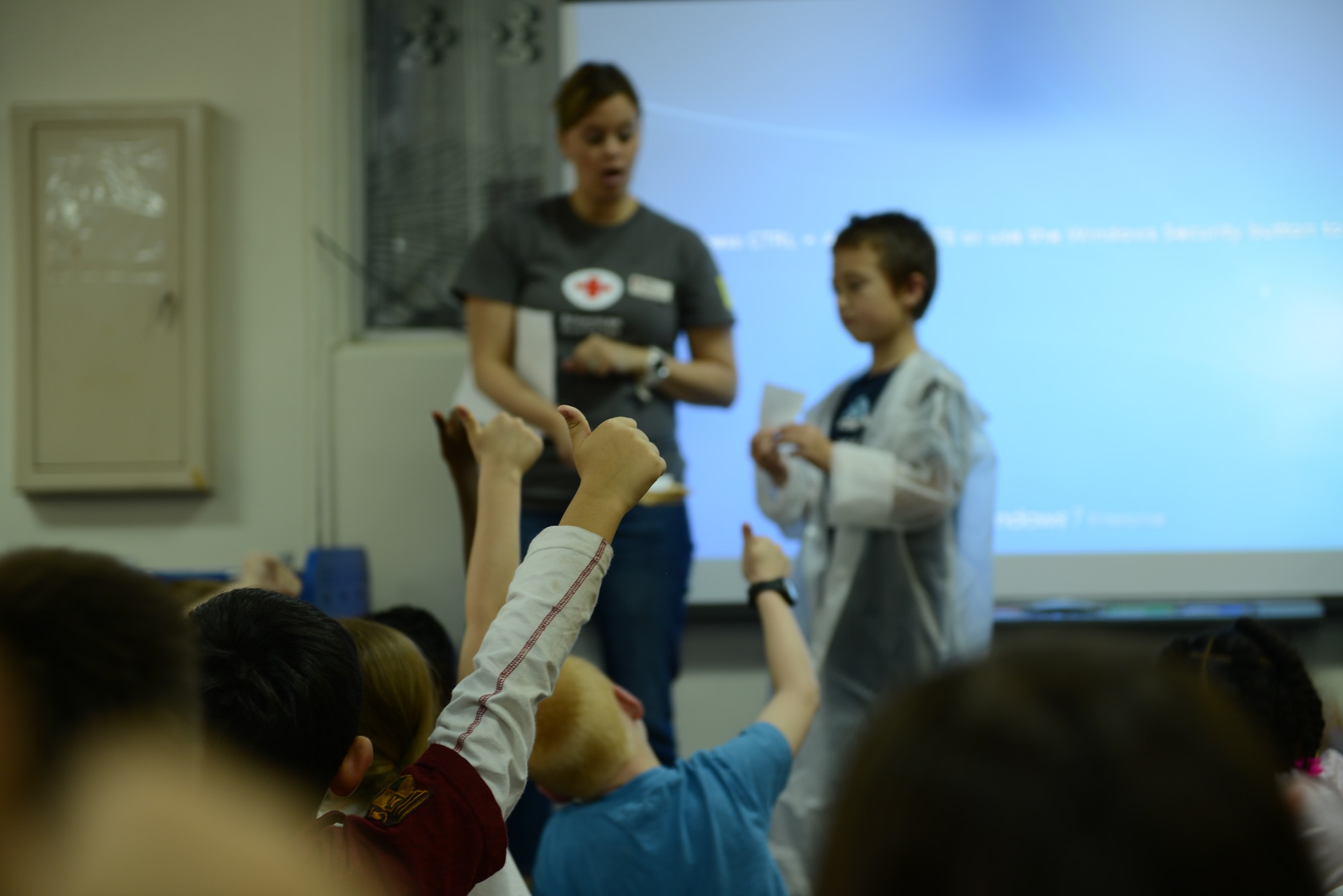 Students at Yokota West Elementary school give the thumbs up during a disaster preparedness presentation Sept. 30, 2014, at Yokota Air Base, Japan. Volunteers from the American Red Cross taught the children to build emergency preparedness kits and had them play a game to demonstrate their knowledge. (U.S. Air Force photo by Senior Airman Desiree Economides/Released)