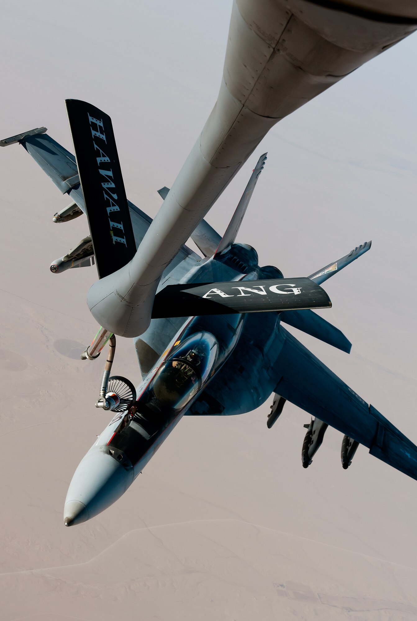 A Hawaii Air National Guard KC-135 refuels an F/A-18. The KC-135 was one of two HIANG Stratotankers deployed to the CENTCOM AOR from July thru October, 2014 (U.S. Air Force photo).