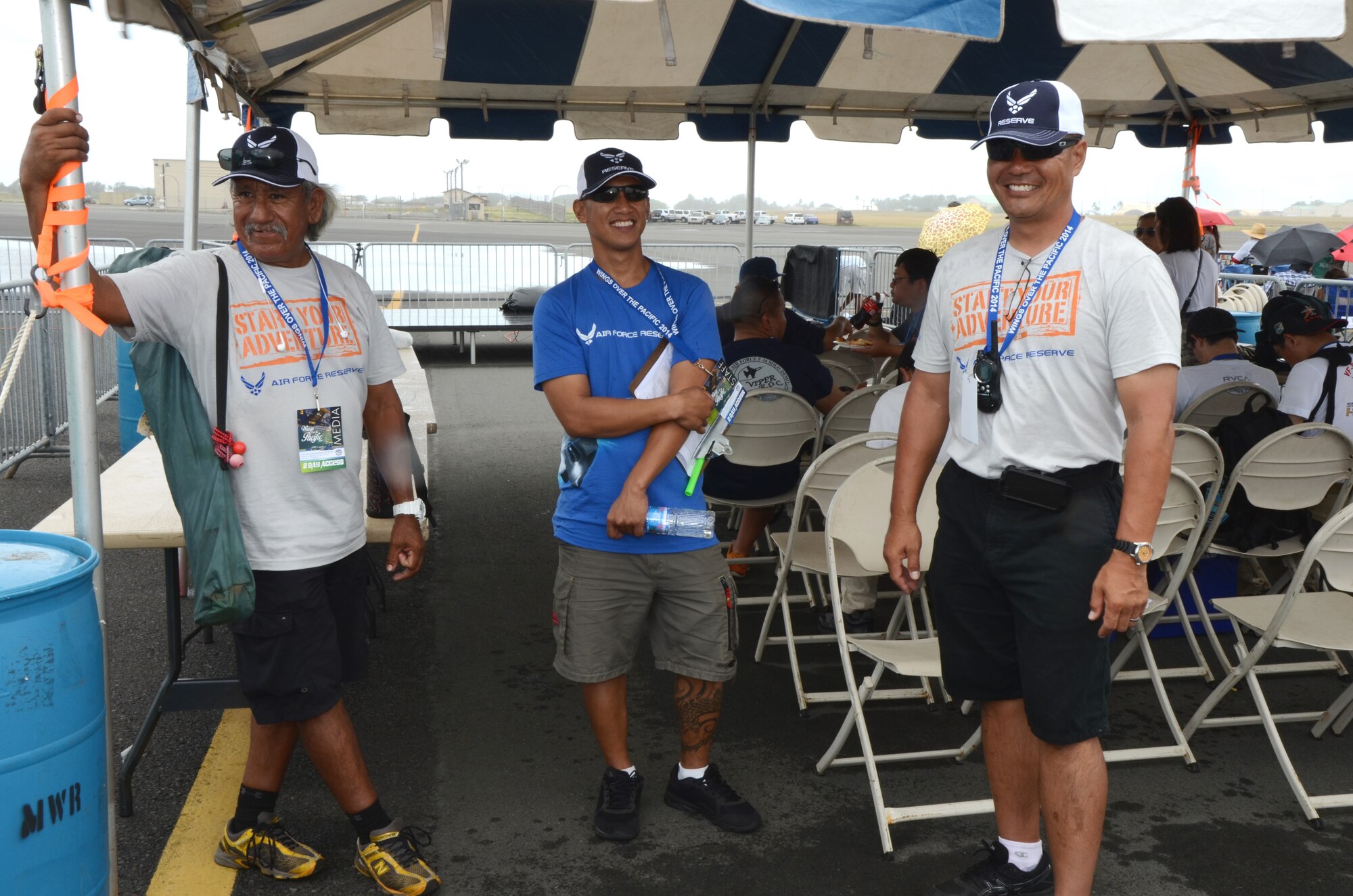 From left, retired Air Force Master Sgt. Larry Castillo formerly with the 48th Aerial Port Squadron, Tech. Sgt. Cris Vida, a security forces member with the 624th Regional Support Group, and Master Sgt. Glenn Park, an air transportation craftsman with the 48th APS, pose for a photo at the entrance to the media tent during the “Wings Over the Pacific” air show, Hickam Field, Hawaii, Sept. 28, 2014. Members of the 624th RSG checked media credentials in support of the Joint Base Pearl Harbor-Hickam, Hawaii, public affairs office during the air show. (U.S. Air Force photo by Tech. Sgt. Phyllis Keith)