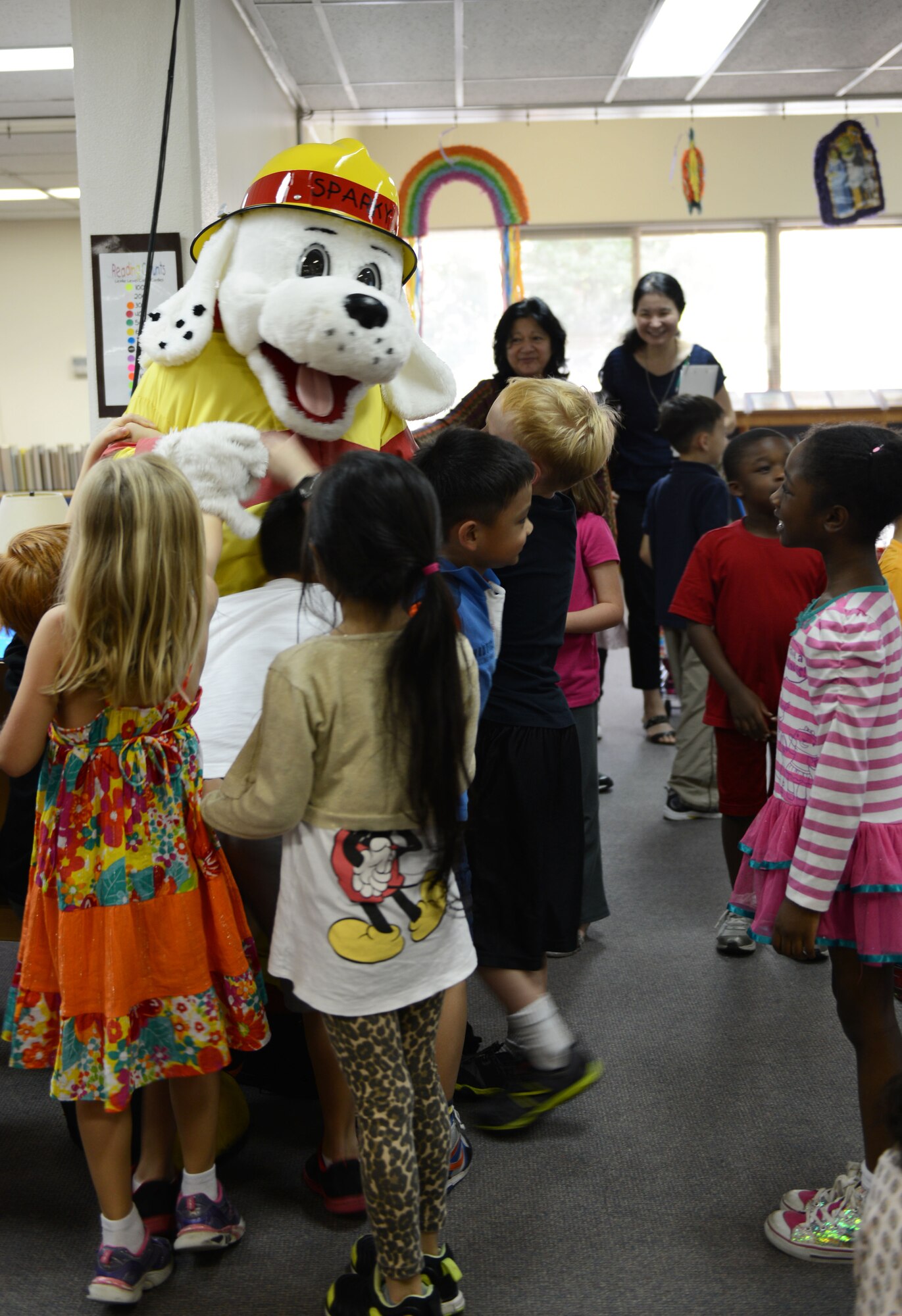 Sparky the Fire Dog visits children at Yokota West Elementary school during a disaster preparedness presentation Sept. 30, 2014, at Yokota Air Base, Japan. The children learned about the various types of disasters and how to build an emergency kit. (U.S. Air Force photo by Senior Airman Desiree Economides/Released)