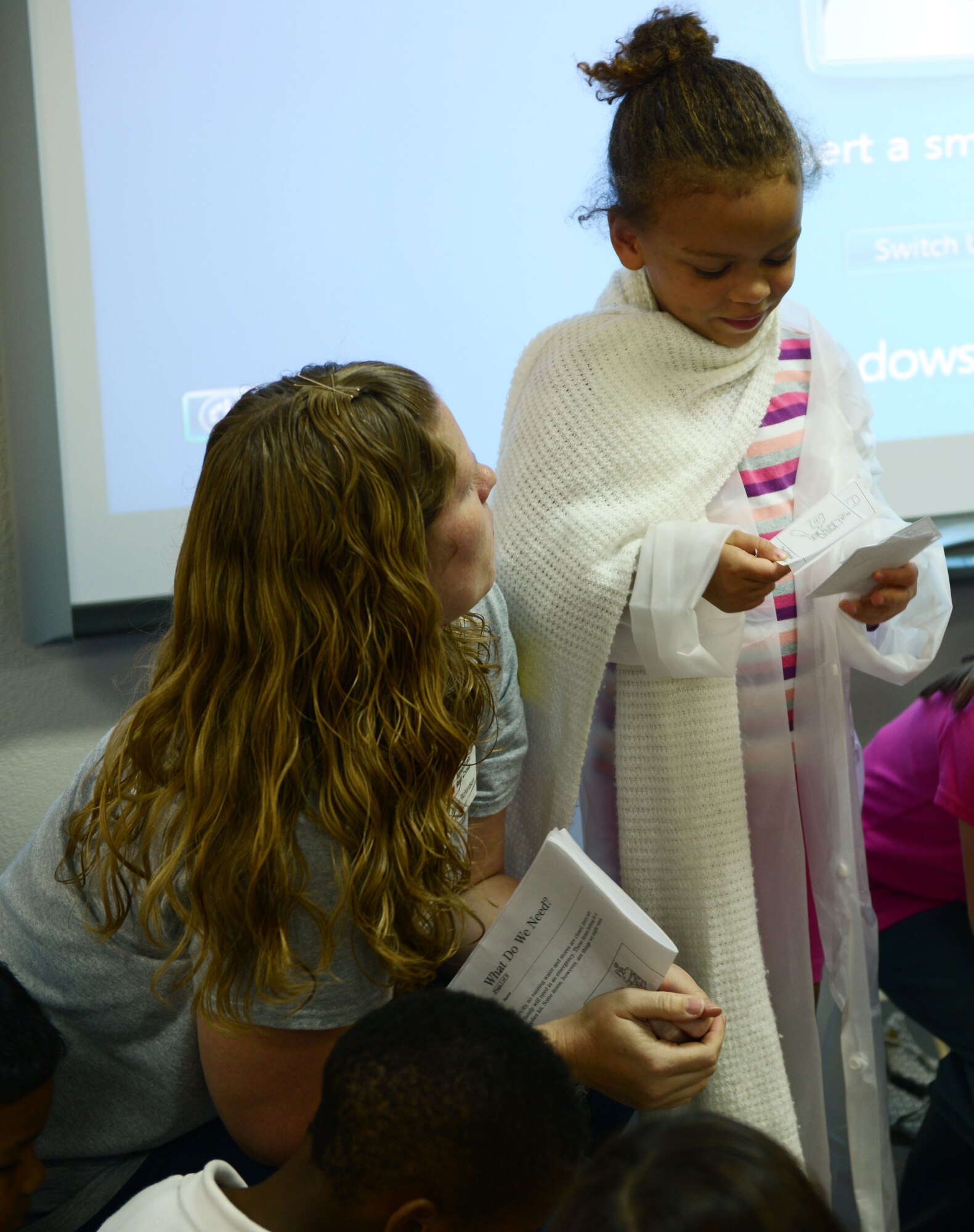 Angela Richardson, left, helps Addison Washington sort items during a disaster preparedness presentation Sept. 30, 2014, at Yokota Air Base, Japan. Richardson, a volunteer with the American Red Cross, taught children at Yokota West Elementary school how to build emergency preparedness kits. (U.S. Air Force photo by Senior Airman Desiree Economides/Released)