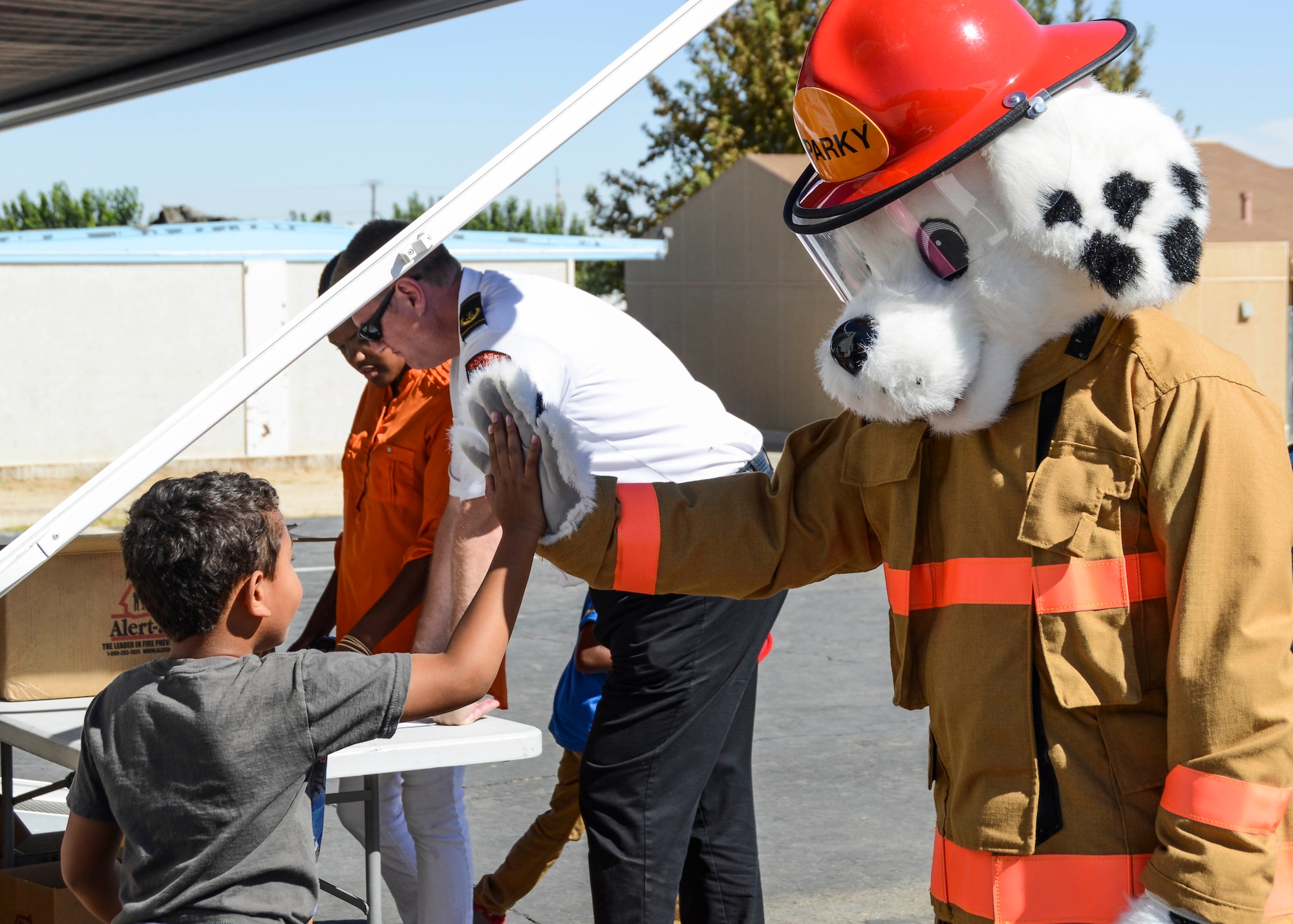 Outside of the Fire Safety Trailer, special guest Sparky the Fire Dog passed out plastic fire-fighter hats and fire-safety goodie bags to students of Branch Elementary Oct. 7. (U.S. Air Force photo by Rebecca Amber)