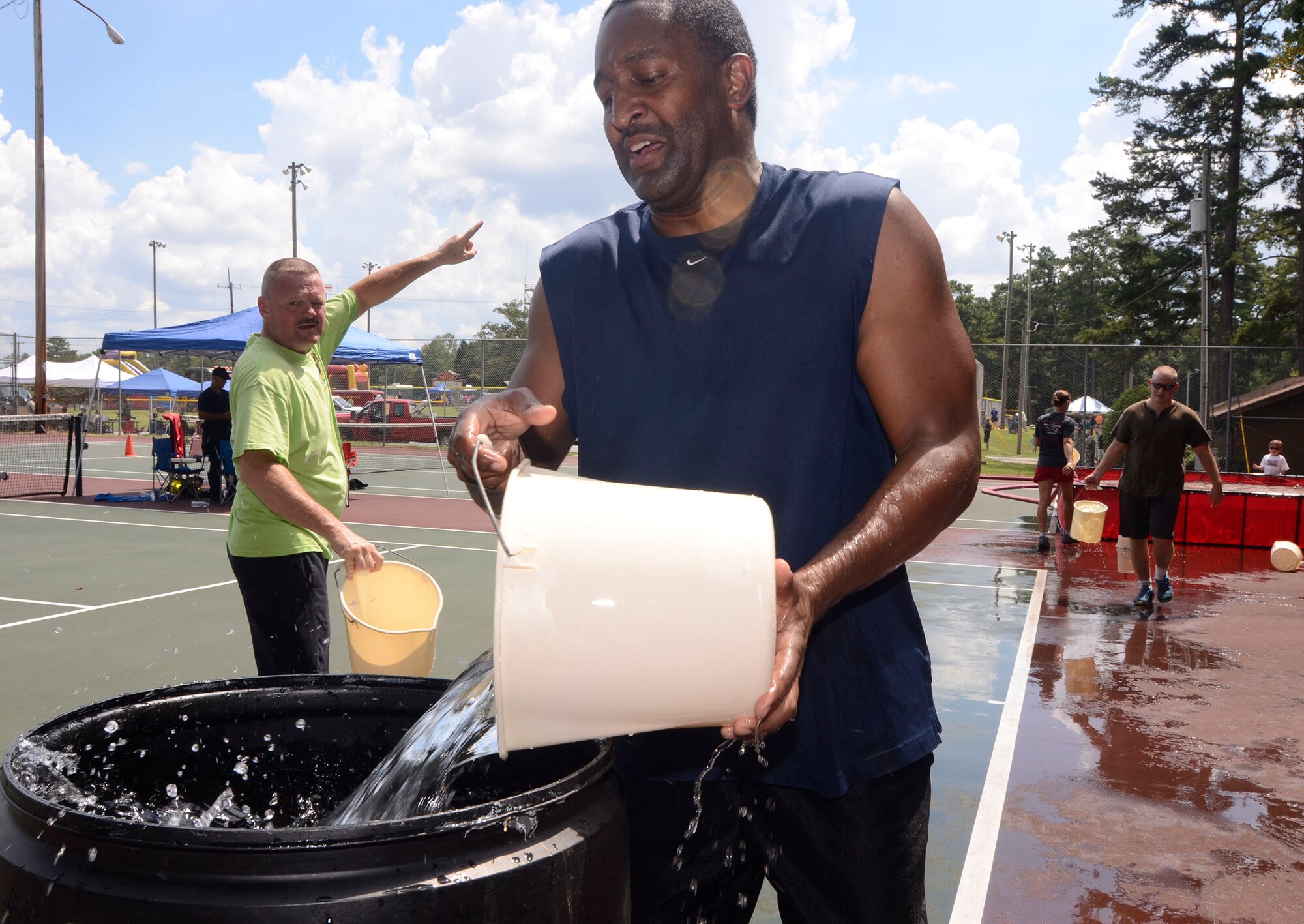 Members of the 94th Aeromedical Staging Squadron participate in team-building activities during the Annual Wing Family Day Sept. 6, 2014 at the Dobbins Lakeside Recreation Area. Attendees also enjoyed music, food, automobile displays, dunking booths, exhibits, vendors, auctions, jumpy castles, face painting, a medieval display, pet adoption, raffles, and Atlanta Falcons ticket giveaways. (U.S. Air Force photo/Don Peek)