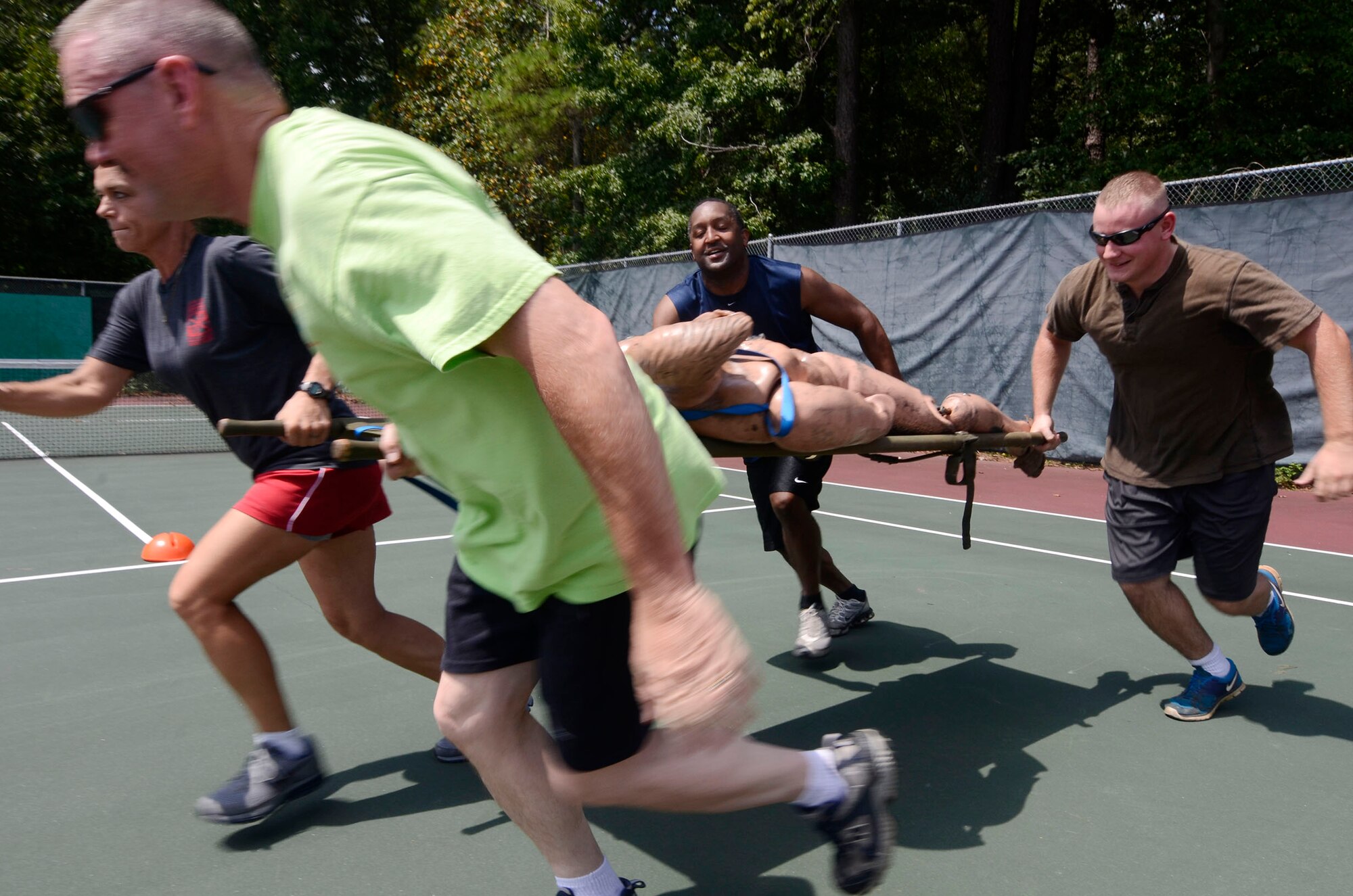 Members of the 94th Aeromedical Staging Squadron participate in team-building activities during the Annual Wing Family Day Sept. 6, 2014 at the Dobbins Lakeside Recreation Area. Attendees also enjoyed music, food, automobile displays, dunking booths, exhibits, vendors, auctions, jumpy castles, face painting, a medival display, pet adoption, raffles, and Atlanta Falcons ticket giveaways. (U.S. Air Force photo/Don Peek)