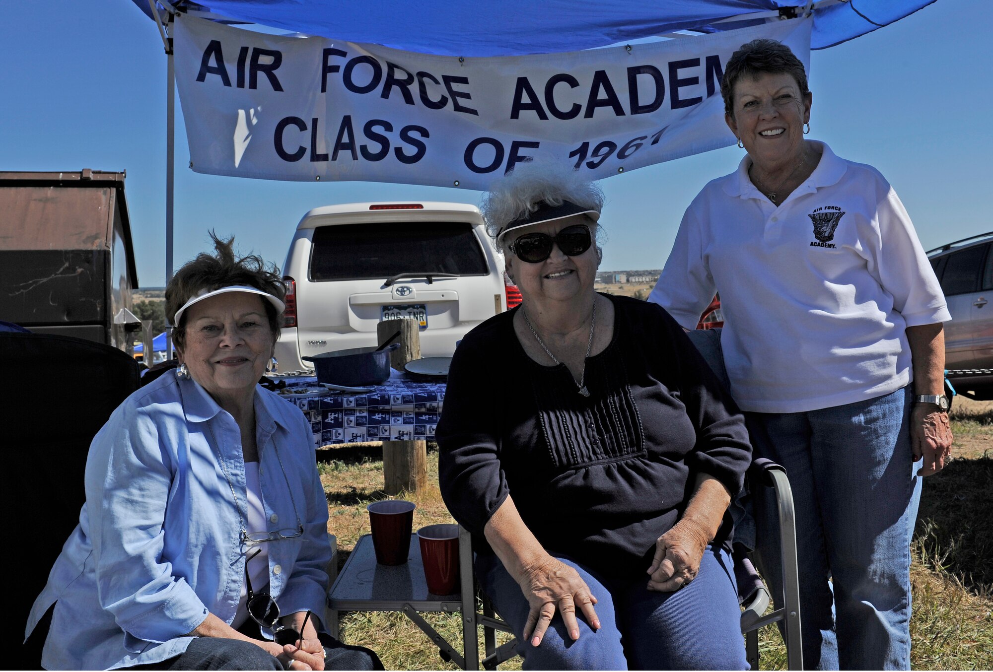 U.S. AIR FORCE ACADEMY, Colo. -- Regular tailgaters and wives of three 1961 Academy graduates, (left to right) Jo Jones, Nancy Wilhelm and Lynda Neel pose for a photo in the tent they spend every Falcon home game under. The ladies have been tailgating at Falcon football games since 1984. Tailgating takes place before every Falcon home game to bring fans together to get pumped for the game. (U.S. Air Force photo/Airman 1st Class Rose Gudex)