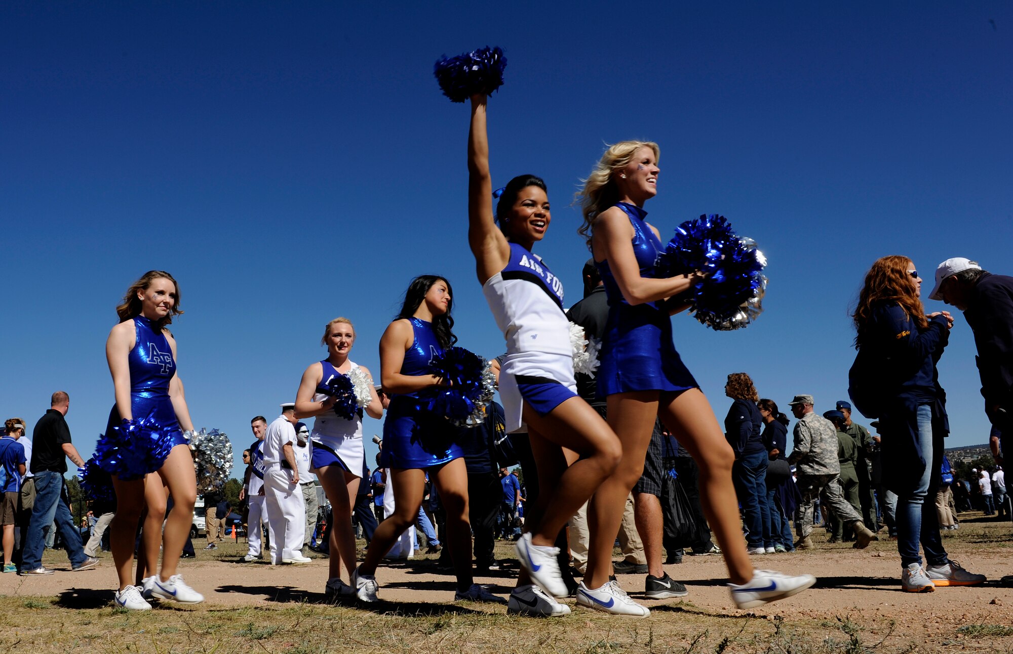U.S. AIR FORCE ACADEMY, Colo. -- Air Force Academy cheerleaders get the tailgaters pumped for the game at the tailgating event outside Falcon Stadium Oct. 4. There was free food for those in attendance provided by the 21st and 50th Space Wings. Tailgating takes place before every Falcon home game to bring fans together to get pumped for the game. (U.S. Air Force photo/Airman 1st Class Rose Gudex)