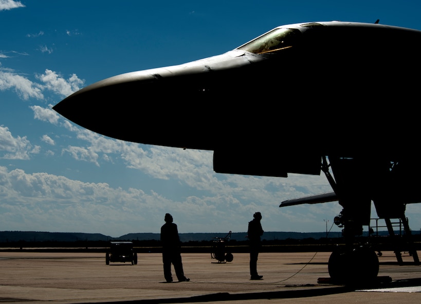 U.S. Air Force crew chiefs from the 7th Aircraft Maintenance Squadron, speak with aircrew on board a B-1B Lancer prior to takeoff Oct. 2, 2014, at Dyess Air Force Base, Texas. Aircrew from 7th Bomb Wing flying squadrons took part in the first flight of a B-1B Lancer upgraded with the Sustainment-Block 16 upgrade outside of operational testing, here Oct. 2. (U.S. Air Force photo by Senior Airman Peter Thompson/Released)