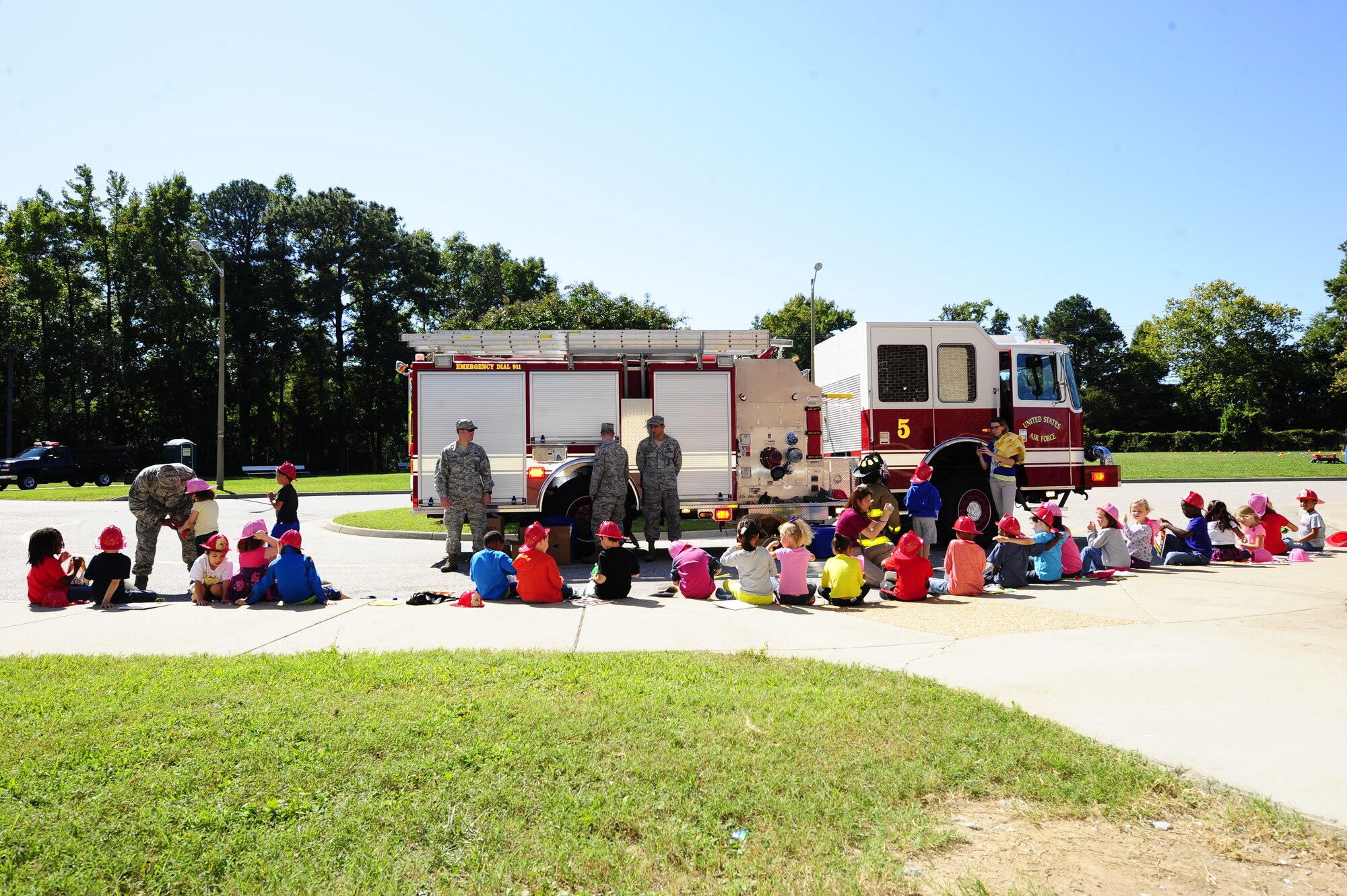 Firefighters from the 633rd Civil Engineer Squadron educate children about fire safety at Bethel Manor Elementary School in Hampton, Va., Oct. 6, 2014. This year’s fire prevention week theme is smoke detector safety. (U.S. Air Force photo by Staff Sgt. Natasha Stannard/Released)