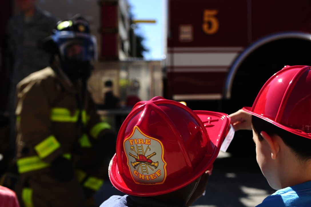 Bethel Manor Elementary School children look through their goody-bags during the 633rd Civil Engineer Squadron fire department’s visit to their school in Hampton, Va., Oct. 6, 2014. During the visit, the firefighters emphasized the importance of knowing what to do in case of a fire. (U.S. Air Force photo by Staff Sgt. Natasha Stannard/Released)