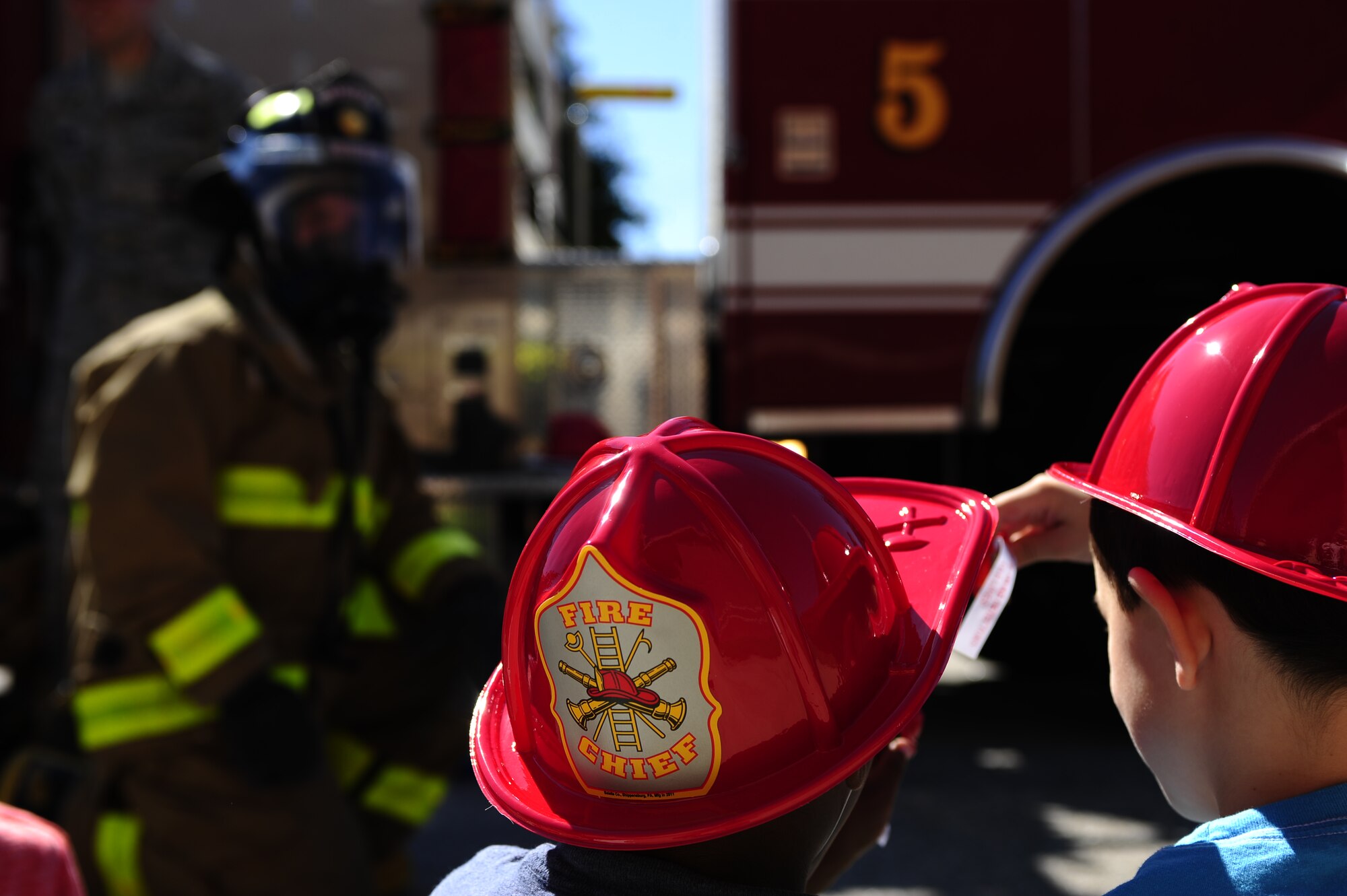 Bethel Manor Elementary School children look through their goody-bags during the 633rd Civil Engineer Squadron fire department’s visit to their school in Hampton, Va., Oct. 6, 2014. During the visit, the firefighters emphasized the importance of knowing what to do in case of a fire. (U.S. Air Force photo by Staff Sgt. Natasha Stannard/Released)