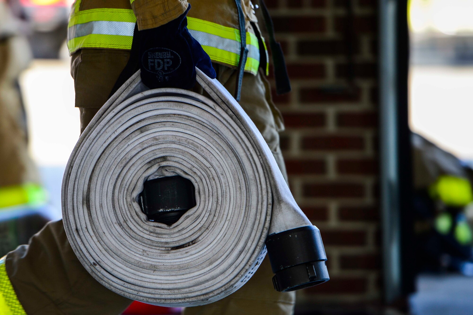 A U.S. Air Force firefighter assigned to the 633rd Civil Engineer Squadron participates in a firefighter challenge at Langley Air Force Base, Va., Oct. 1, 2014.  The challenge tested firefighters on their ability to perform various tasks needed to combat fires. (U.S. Air Force photo by Senior Airman Kayla Newman/Released)