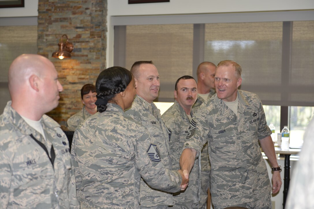 Chief Master Sergeant of the Air Force James Cody greets Master Sgt. Meiko Nichols of the Air Forces Northern Intelligence Directorate during a visit with some AFNORTH enlisted Oct. 7.  Cody received a mission briefing, held a question-and-answer session and recognized two members, Master Sgt. Mickie Reinhart-Newman of AFNORTH’s command section and Staff Sgt. Theresa Carter-Daniel of the Air Force Rescue Coordination Center, each with his coin (Photo by Mary McHale)