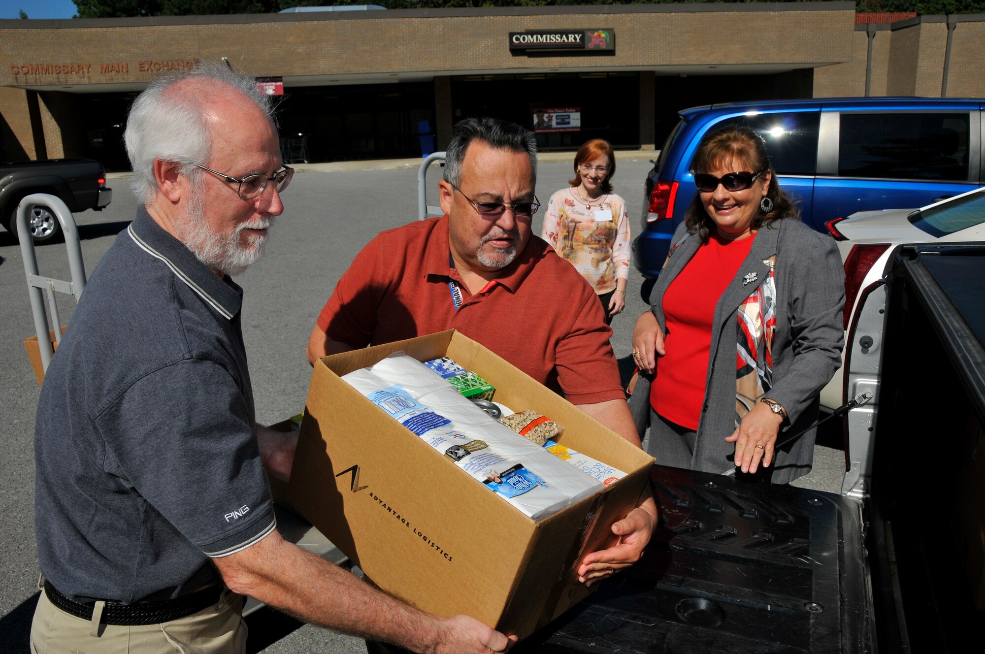 Arnold Engineering Development Complex (AEDC) Feds Feed Families volunteers (left to right) Dr. Ralph Jones, Armando Aguirre, Kathy Pelton – with Tullahoma Good Samaritan, and Peggy Proffitt load donated items for Good Samaritan into cars on Sept. 25 at AEDC. IAW DODI 5040.02 Ecl. 10, a portion of this image has been masked as part of our security posture. The image containing the masked portion is approved for public release. (Photo by Rick Goodfriend)