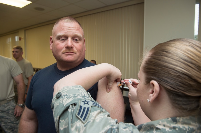 Master Chief Petty Officer Joe Gardner, Naval Support Activity command master chief , receives his seasonal flu shot Oct. 7, 2014, at Joint Base Charleston, S.C. Flu shots are now available for all active-duty service members and children at the 628th Medical Group. (U.S. Air Force photo/Senior Airman George Goslin)