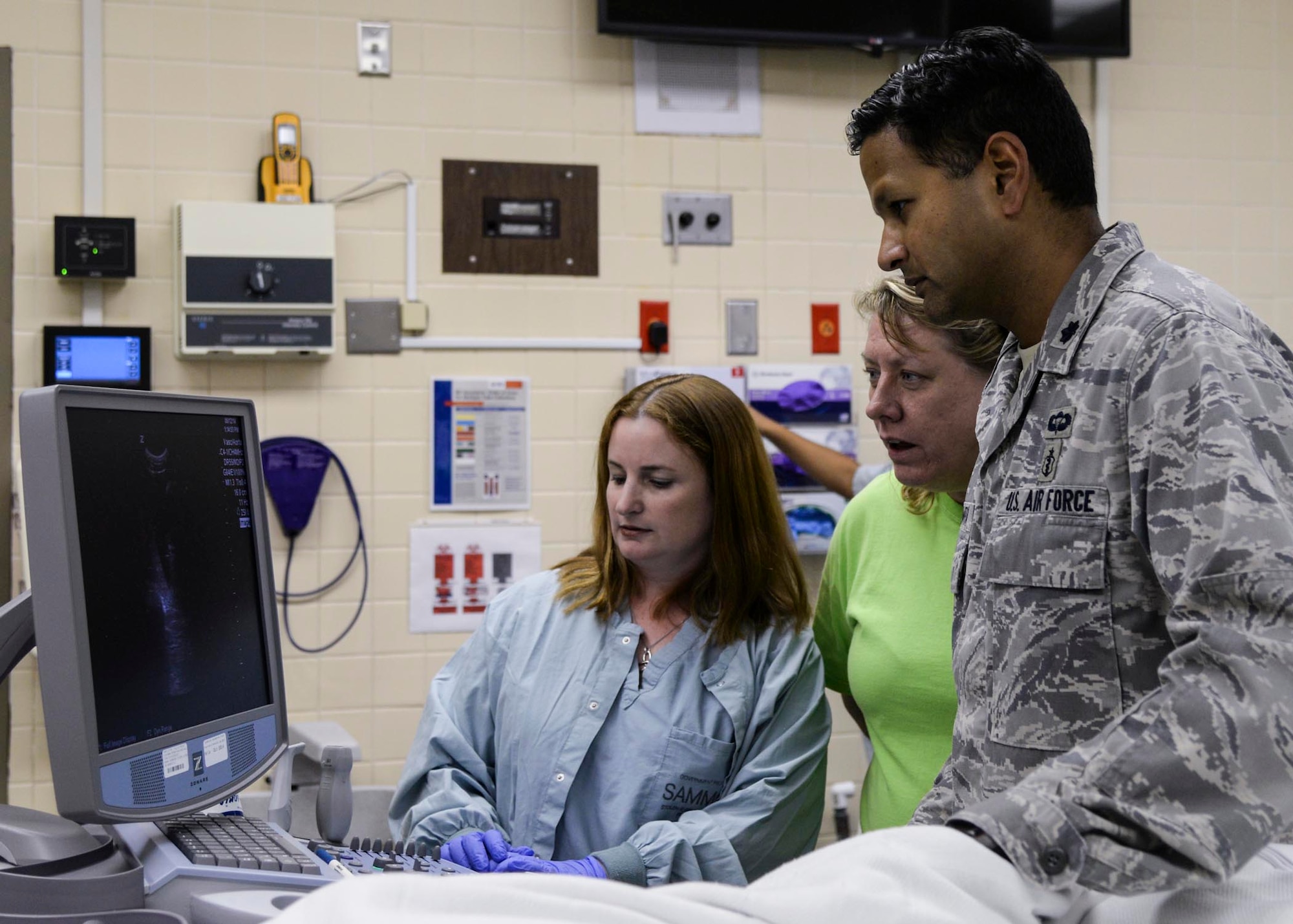 U.S. Air Force Lt. Col. Vikhyat Bebarta, director of the 59th Medical Wing En Route Care Research Center (ECRC) and chief of medical toxicology at the San Antonio Military Medical Center on nearby Joint Base San Antonio-Fort Sam Houston, runs an ultrasound on a patient with fellow research technicians at the Wilford Hall Ambulatory Surgical Center, Joint Base San Antonio-Lackland, Texas, July 22. Bebarta garnered the Gen. Paul W. Myers award and the National Society for Academic Emergency Medicine Basic Science award. (U.S. Air Force photo/Staff Sgt. Kevin Iinuma)