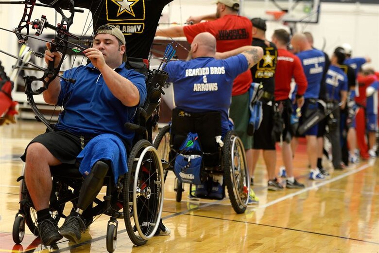 U.S. Air Force Staff Sgt. Seth Pena, left, competes in archery during the 2014 Warrior Games Oct. 1, 2014, at the U.S. Olympic Training Center in Colorado Springs, Colorado. The Warrior Games consist of athletes from the Defense Department, who compete in Paralympic-style events for their respective military branch. The goal of the games is to help highlight the potential of warriors through competitive sports. (U.S. Air Force photo/Tim Chacon)