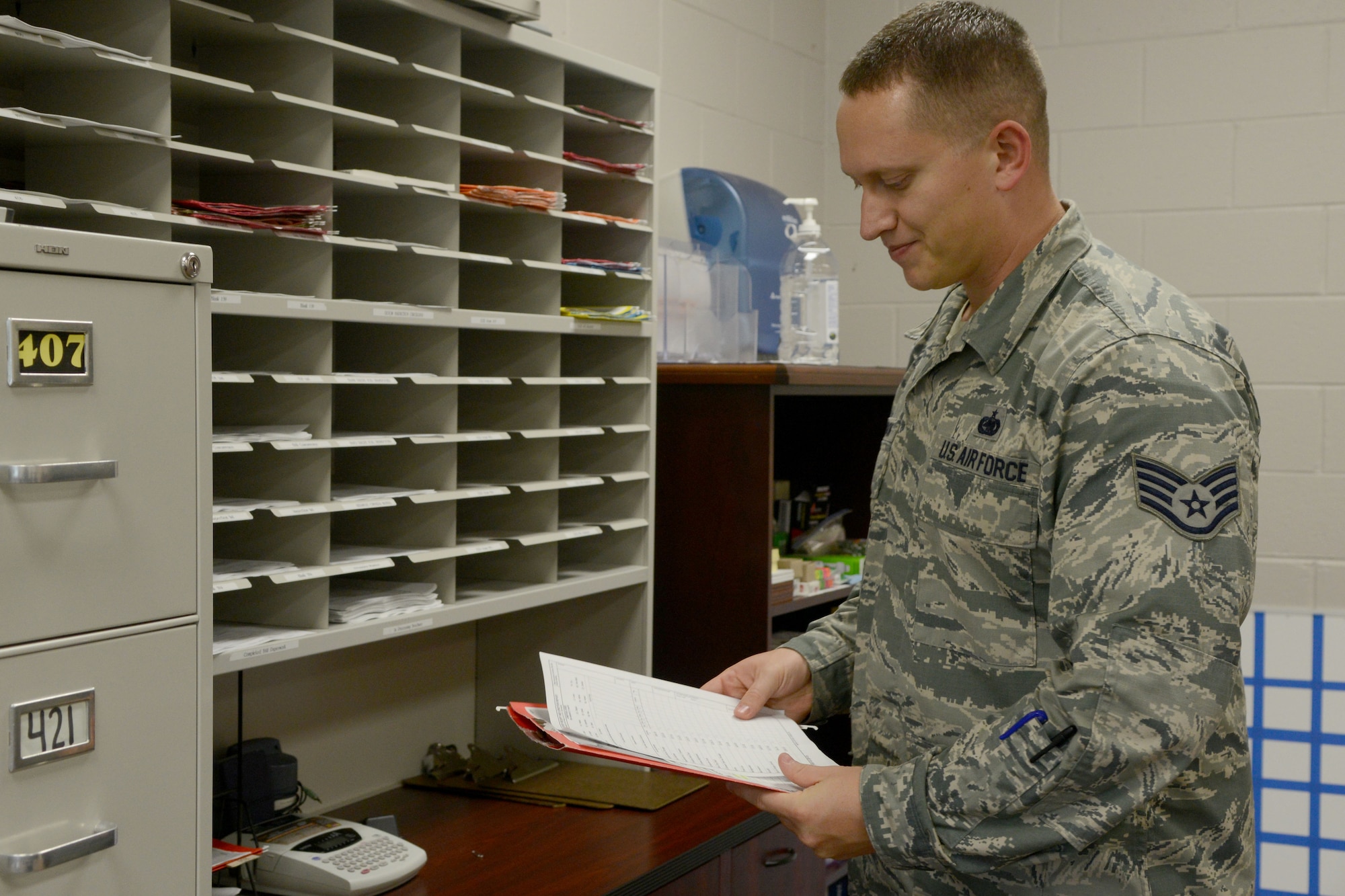 U.S. Air Force Staff Sgt. Matthew Robinson, 20th Civil Engineer Squadron Airman dormitory leader, prepares to in-process a new Airman at the dorms, Oct. 3, 2014, Shaw Air Force Base, S.C. Dormitory leaders are  in charge of assigning new Team Shaw service members a room upon arrival to the base. (U.S. Air Force photo by Senior Airman Ashley L. Gardner/Released)
