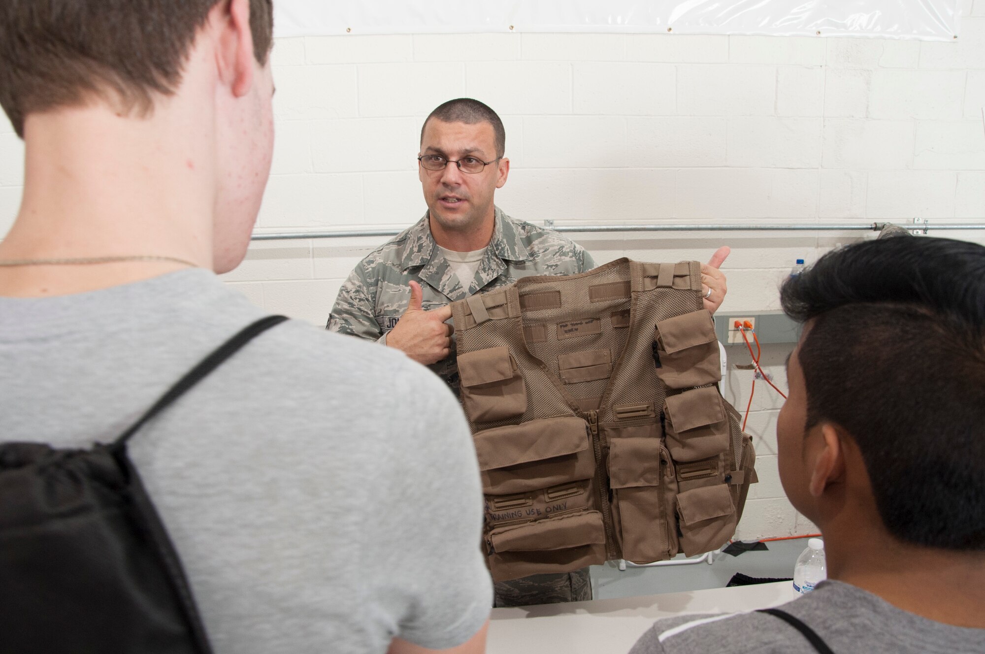 Staff Sgt. Jacob Johnson, 436th Operations Support Squadron aircrew flight equipment training instructor, shows an Air Ace Vest to high school students during the Aviation Education Day October 3, 2014, at the Sussex County Airport in Georgetown, Del.  Team Dover Airmen talked with juniors and seniors from around the state about each of the different jobs in the Air Force. (U.S. Air Force photo/Senior Airman Jared Duhon)