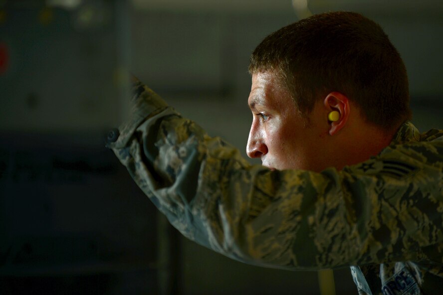 U.S. Air Force Senior Airman Richard Hamrick, 20th Equipment Maintenance Squadron weapons load crew member, observes his team as they load an MK-82 slick missile onto an F-16CM Fighting Falcon at Shaw Air Force Base, S.C., Oct. 3, 2014. Hamrick was participating in a weapons load crew of the quarter competition where four teams competed for accuracy and best time. (U.S. Air Force photo by Airman 1st Class Jensen Stidham/Released)