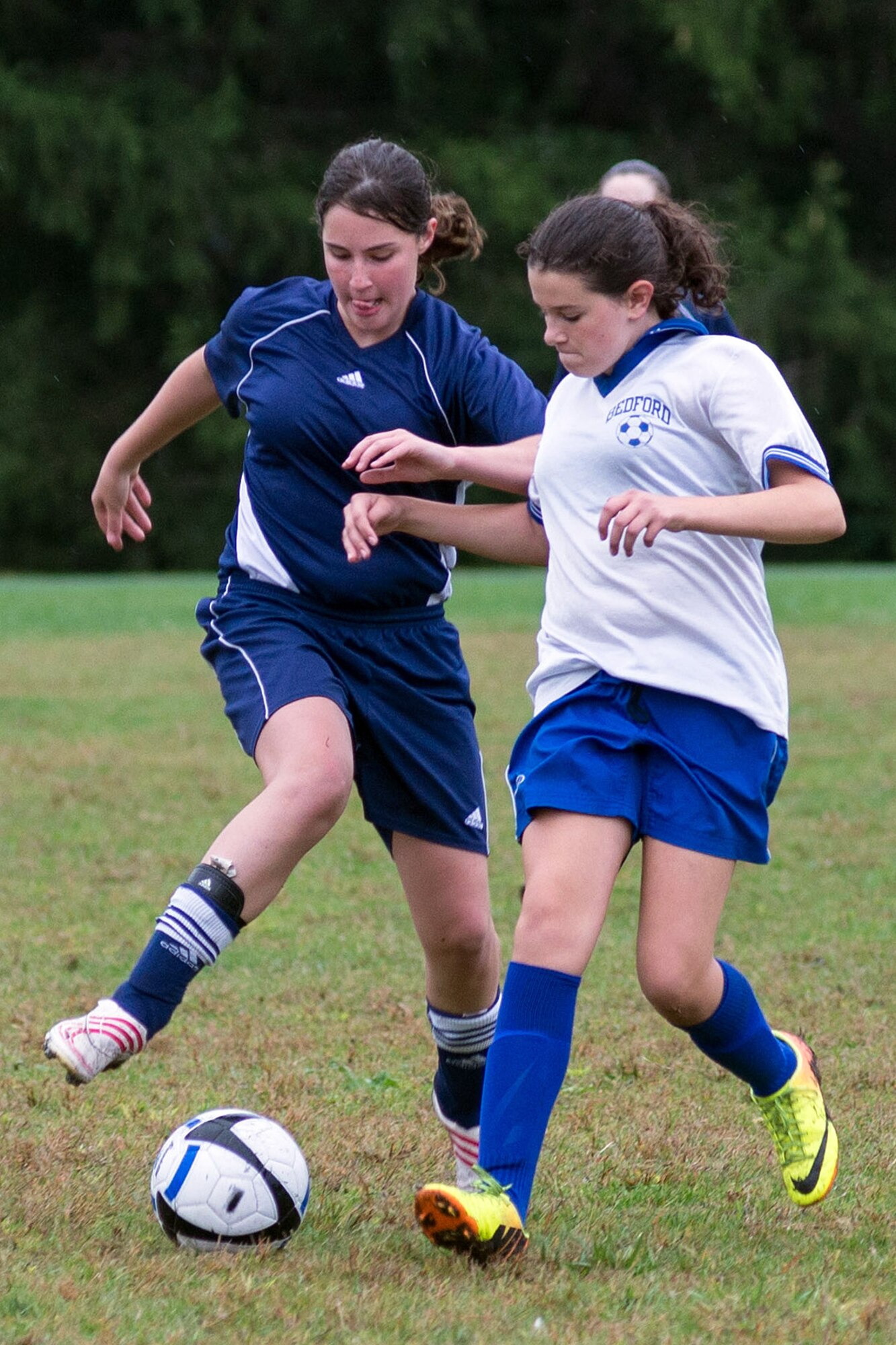 Megan McKenna (left), a member of the Hanscom Middle School Falcons girls’ soccer team, competes for the ball during a home match against the Bedford Middle School team at the base track Sept 30. The Hanscom Middle School team lost the game to Bedford. (U.S. Air Force photo by Mark Herlihy)