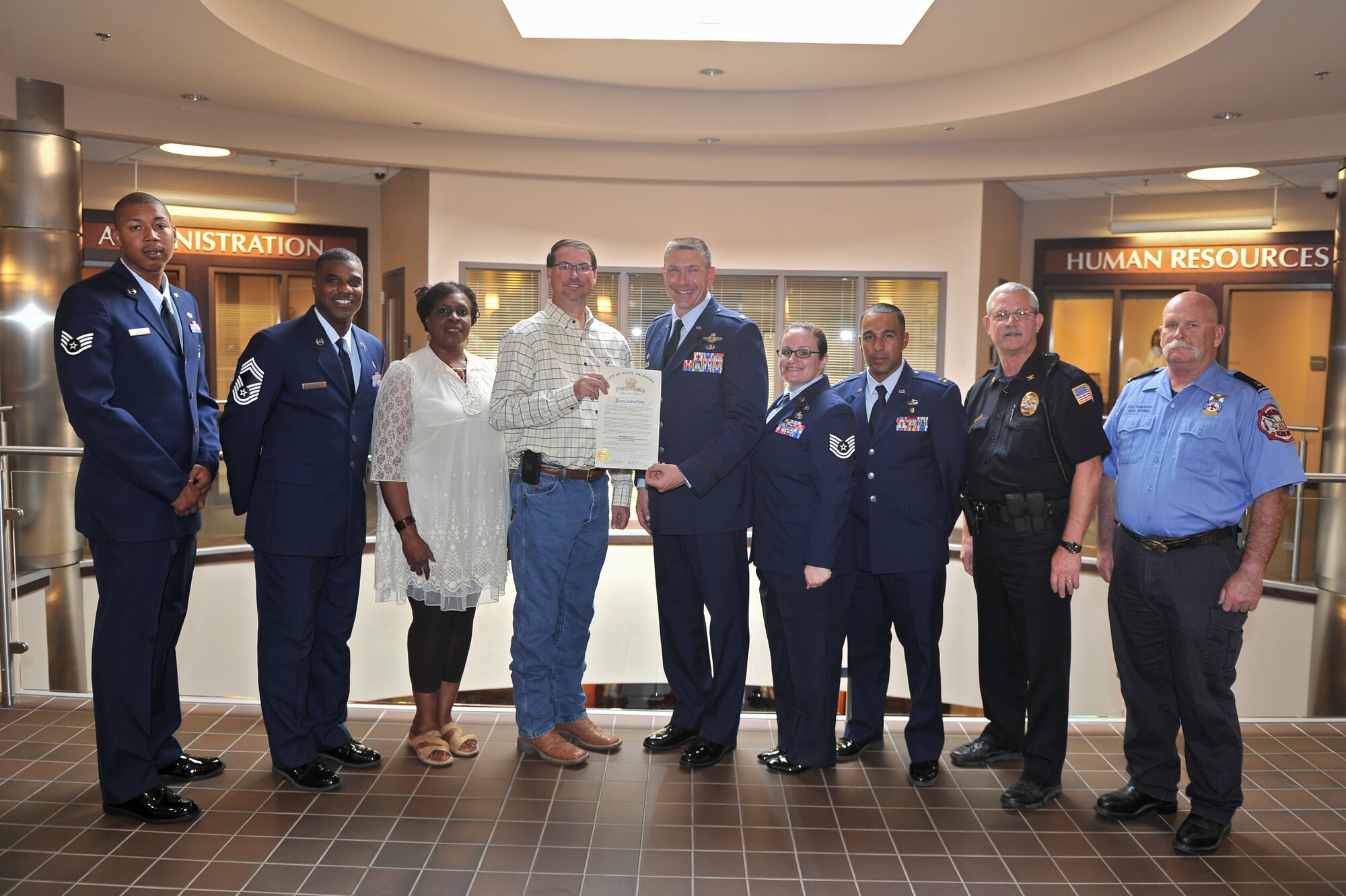ALTUS, Okla. – Members of Altus Air Force Base and the City of Altus stand with a signed Red Ribbon Week proclamation Oct. 6, 2014. The week will be recognized from Oct. 24-31, 2014. Altus AFB and the City of Altus partnered to help campaign for a community free of drugs and the violence that accompanies it. Additionally, Altus AFB and the City of Altus will be hosting various local drug education events at local schools to help prevent drug use. (U.S. Air Force photo by Senior Airman Dillon Davis/Released)
