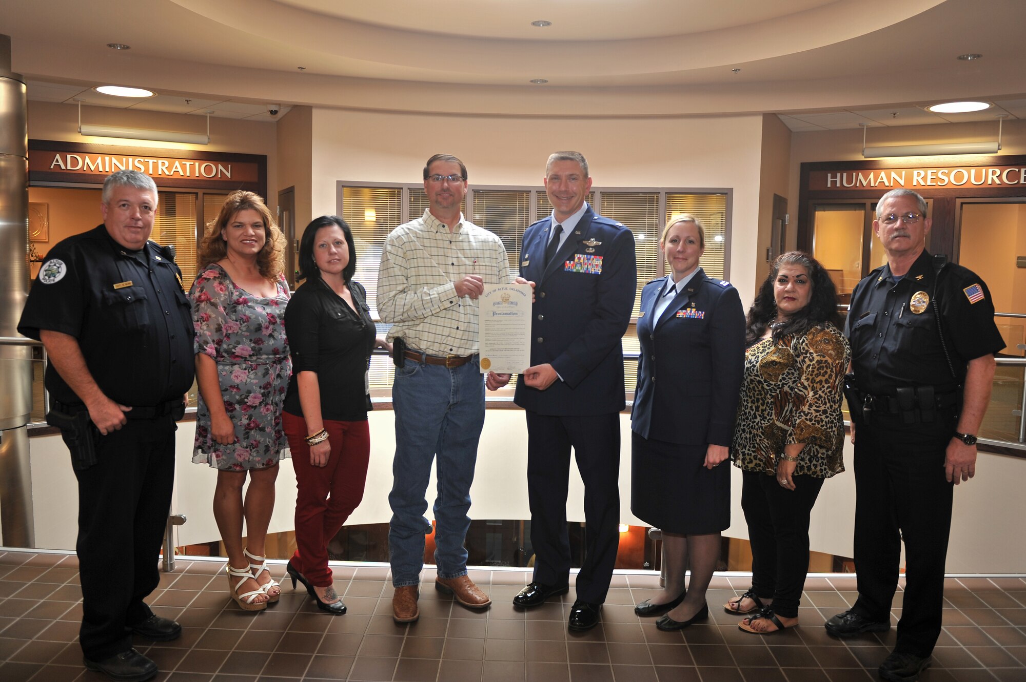 ALTUS, Okla. – Members of Altus Air Force Base and the City of Altus stand with a signed Domestic Violence Prevention Month proclamation Oct. 6, 2014. Altus AFB and the City of Altus will continually work together to put an end to domestic violence. In addition to campaigning for awareness, Altus AFB and the City of Altus have been providing support and safety to victims of domestic violence through the local Acmi House Crisis Center. (U.S. Air Force photo by Senior Airman Dillon Davis/Released)