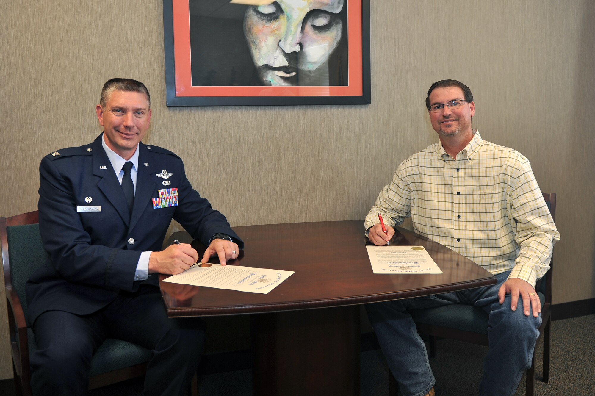 ALTUS, Okla. – U.S. Air Force Col. Bill Spangenthal, 97th Air Mobility Wing commander, and City of Altus Mayor David Webb, sign Domestic Violence Prevention Month and Red Ribbon Week proclamations Oct. 6, 2014. Domestic Violence Prevention Month will be all of October and Red Ribbon Week will take place Oct. 24-31, 2014. Red Ribbon Week is a part of the campaign for a drug-free America and Altus AFB and the City of Altus will be hosting various local drug education events at local schools to help prevent children from experimenting with illegal substances. (U.S. Air Force photo by Senior Airman Dillon Davis/Released)