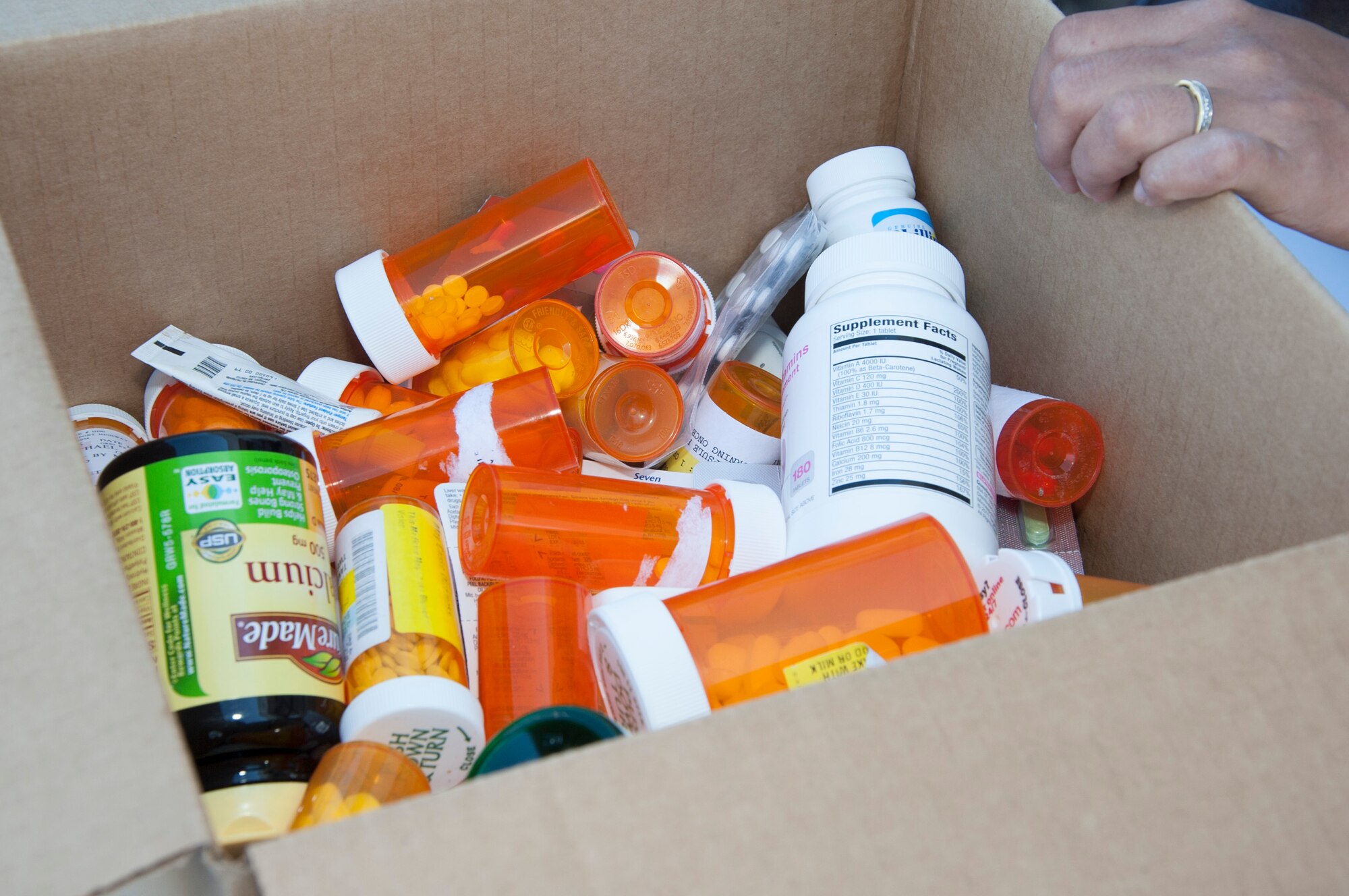 Medicine is gathered in a box during National Drug Take Back Day Sept. 27, 2014, in front of the commissary on Dover Air Force Base, Del.  The day was a cooperative effort between the 436th Security Forces Squadron, 436th Medical Support Squadron pharmacy and the Drug Enforcement Administration to rid homes of potentially dangerous expired, unused and unwanted prescription drugs. (U.S. Air Force photo/Senior Airman Jared Duhon) 