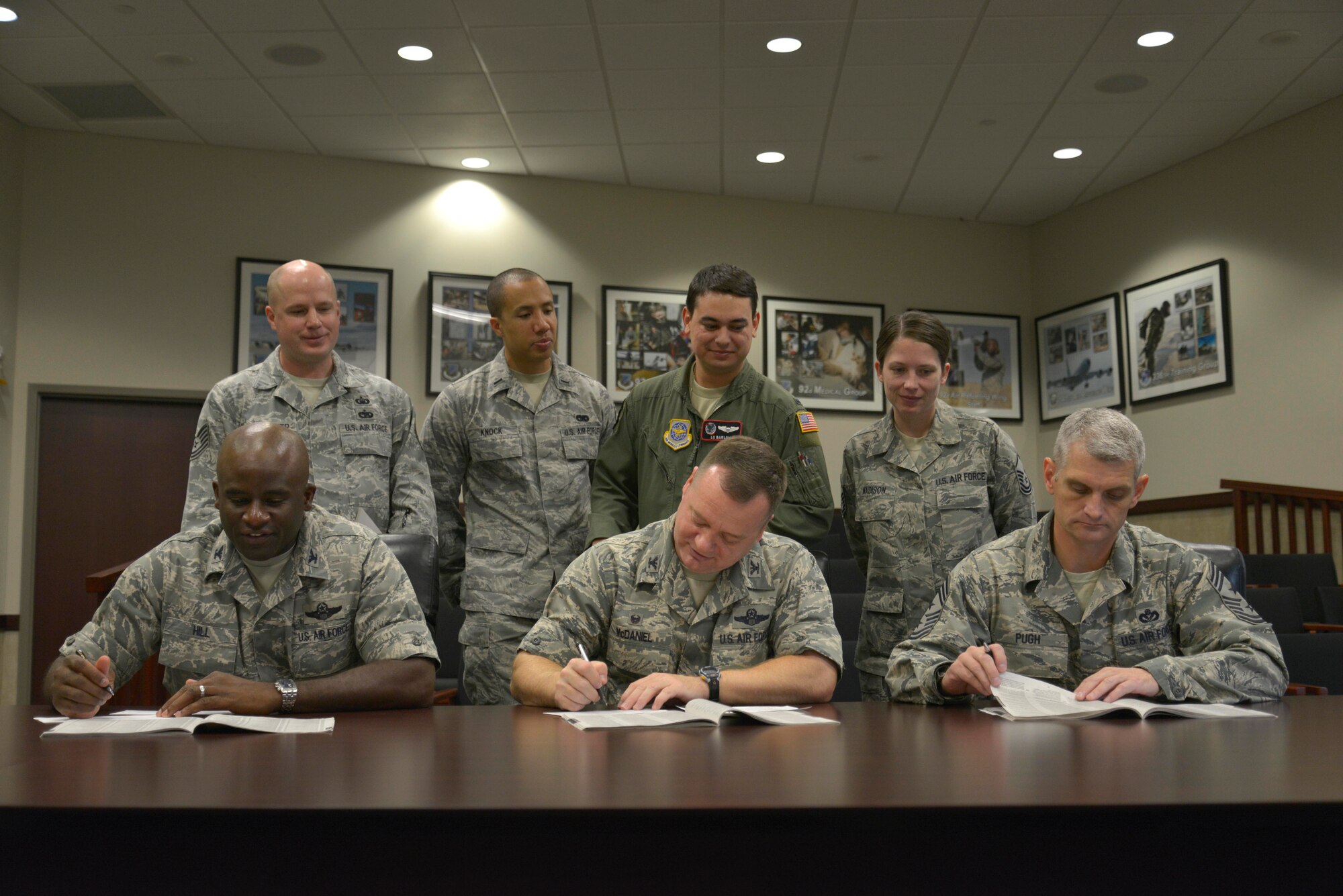 Col. Brian Hill, 92nd ARW vice commander, Col. Brian McDaniel, 92nd Air Refueling Wing commander, and Chief Master Sgt. Christian Pugh, 92nd ARW command chief, donate to the Combined Federal Campaign along with the CFC group representatives Oct. 7, 2014, at Fairchild Air Force Base, Wash. The CFC is the world's largest and most successful annual workplace charity campaign, with more than 150 CFC national and international campaigns raising millions of dollars each year. (U.S. Air Force photo by Airman 1st Class Janelle Patiño)