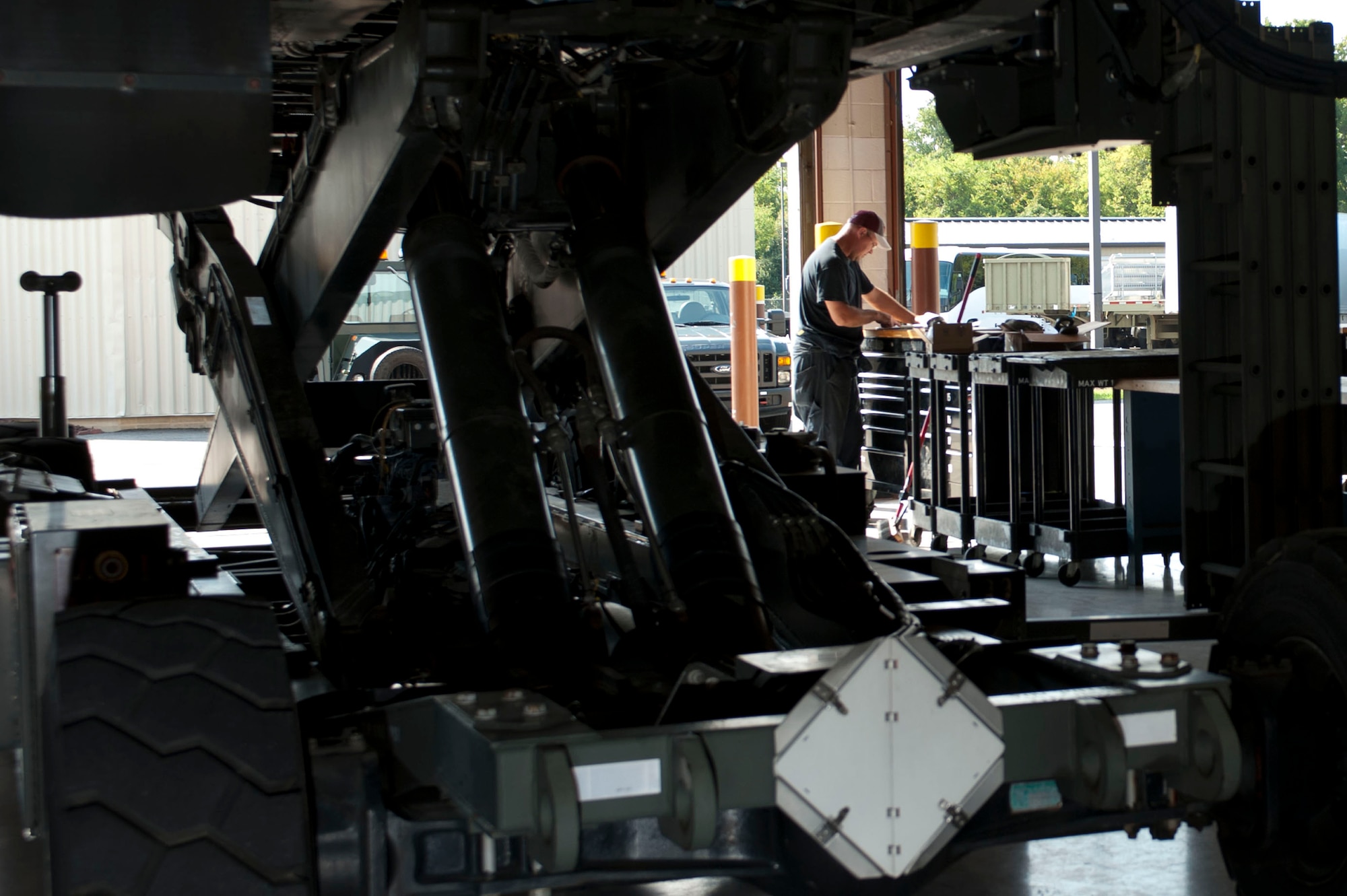 David Davidson, 633rd Logistics Readiness Squadron vehicle maintainer, reviews technical orders for a 25K loader at Langley Air Force Base, Va., Oct. 1, 2014. Davidson checked the orders after fixing the loader’s transport operation system. This system allows the vehicle to rise up to aircraft for loading and unloading materials. (U.S. Air Force photo by Staff Sgt. Natasha Stannard/Released)