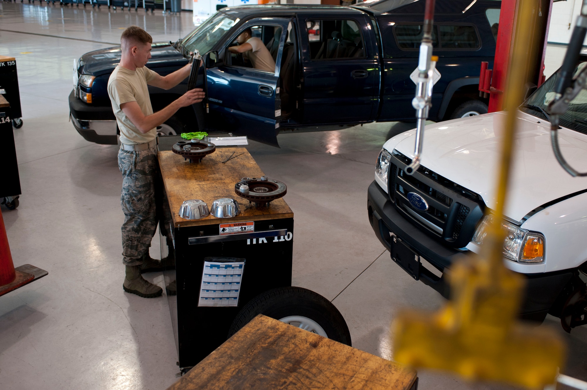 U.S. Air Force Staff Sgt. Josh Phillips, 633rd Logistics Readiness Squadron vehicle maintainer, cleans his work station after conducting a periodic maintenance check on a government vehicle at Langley Air Force Base, Va., Oct. 1, 2014. Maintainers conduct inspections based on specific vehicles’ hours, miles or usage to ensure mission readiness for various squadrons on base. (U.S. Air Force photo by Staff Sgt. Natasha Stannard/Released)
