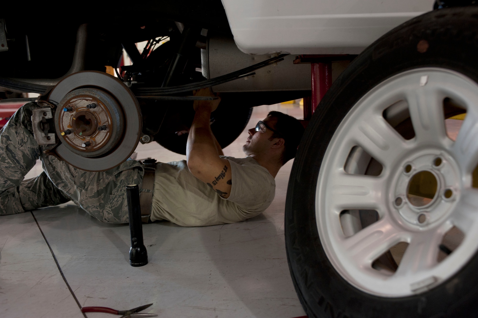 U.S. Air Force Staff Sgt. John Stark, 633rd Logistics Readiness Squadron vehicle maintainer, inspects a government vehicle’s differential at Langley Air Force Base, Va., Oct. 1, 2014. The differential sends engine power to the wheels and controls the speed of the wheels. (U.S. Air Force photo by Staff Sgt. Natasha Stannard/Released) 
