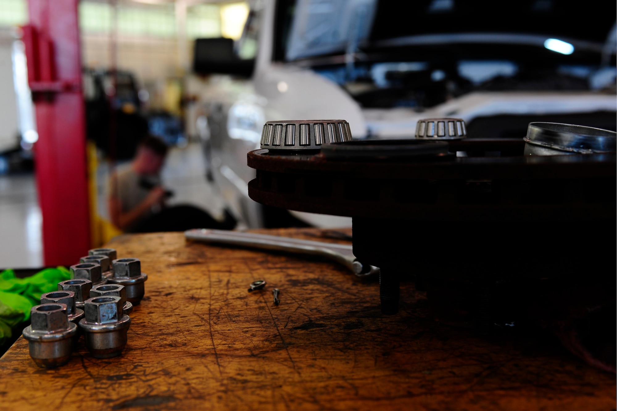 U.S. Air Force Staff Sgt. Josh Phillips, 633rd Logistics Readiness Squadron vehicle maintainer, conducts a wheel-baring and break inspection on a government vehicle at Langley Air Force Base, Va., Oct. 1, 2014. Vehicle maintainers accomplish approximately 2,400 repairs annually on Joint Base Langley-Eustis vehicles. (U.S. Air Force photo by Staff Sgt. Natasha Stannard/Released)