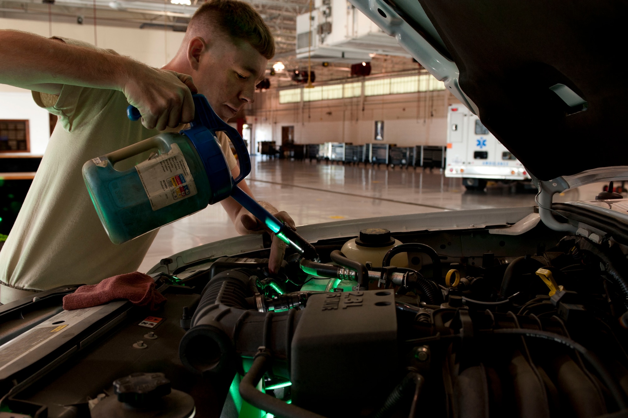 U.S. Air Force Staff Sgt. Josh Phillips, 633rd Logistics Readiness Squadron vehicle maintainer, fills a government vehicle’s windshield wiper fluid tank at Langley Air Force Base, Va., Oct. 1, 2014. Phillips did this as part of the vehicle’s periodic maintenance inspection. The inspection reduces the potential for breakdowns, which can drive higher repair costs if left unattended. (U.S. Air Force photo by Staff Sgt. Natasha Stannard/Released)