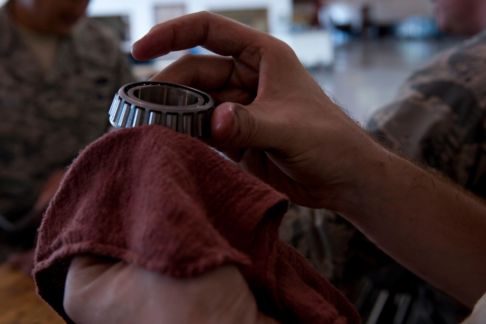 U.S. Air Force Staff Sgt. Josh Phillips, 633rd Logistics Readiness Squadron vehicle maintainer, cleans a wheel bearing at Langley Air Force Base, Va., Oct. 1, 2014. Phillips cleaned this as part of government vehicle’s wheel-bearing and break inspection. Phillips conducts inspections to ensure proper configuration, functionality and serviceability standards are sustained. (U.S. Air Force photo by Staff Sgt. Natasha Stannard/Released)