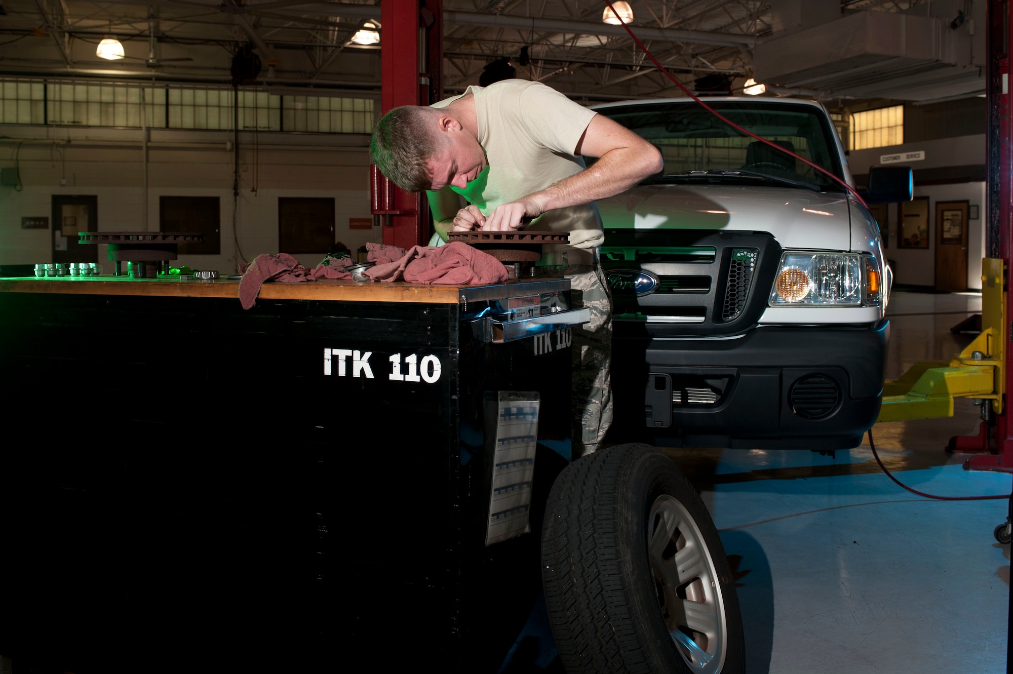 U.S. Air Force Staff Sgt. Josh Phillips, 633rd Logistics Readiness Squadron vehicle maintainer, inspects a government vehicle’s brakes as part of a periodic maintenance inspection at Langley Air Force Base, Va., Oct. 1, 2014.  Periodic inspections ensure safety related inspections, adjustments and services recommended by the manufacturer’s applicable technical orders are performed.  (U.S. Air Force photo by Staff Sgt. Natasha Stannard/Released)