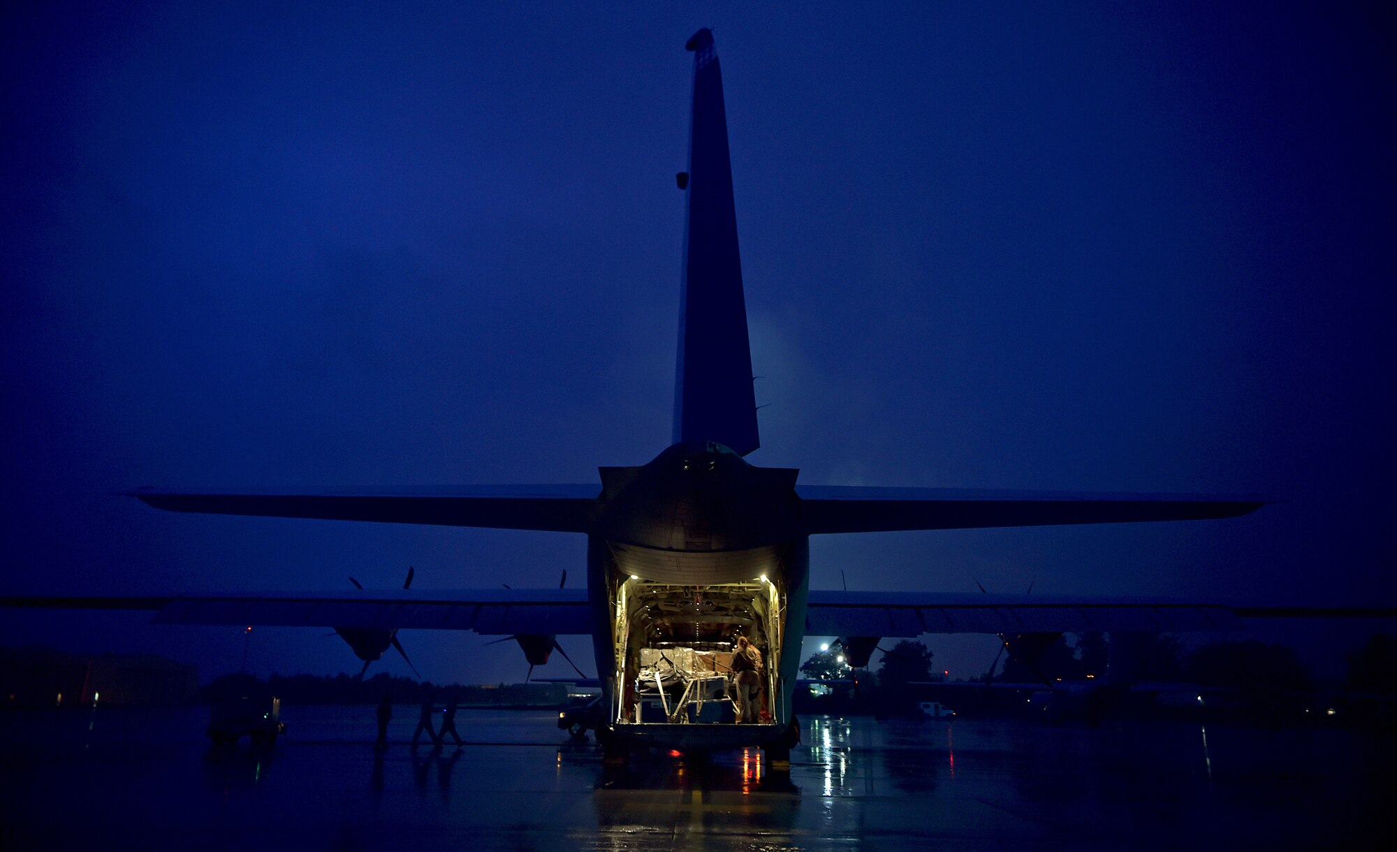 Staff Sgt. Cassandra Hancock, load master with the 37th Airlift Squadron, prepares cargo on the ramp of a C-130-J Super Hercules prior to a mission in support of the Ebola virus epidemic, Oct. 7, 2014, at Ramstein Air Base, Germany. As the Ebola outbreak becomes a potential global threat, U.S. Africa Command is working in support of the U.S. Agency for International Development, the lead federal agency (LFA), as part of a comprehensive U.S. Government effort to respond to and contain the outbreak of the Ebola virus in West Africa as quickly as possible.  This was the first C-130J Super Hercules flight launched from Ramstein to Monrovia, Liberia in support of Operation UNITED ASSISTANCE. (U.S. Air Force photo by/Staff Sgt. Sara Keller)