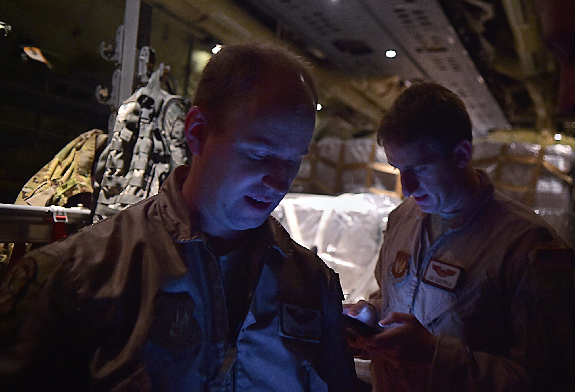 U.S. Air Force Capt. Brian Shea and Capt. Joe Eastman, pilots with the 37th Airlift Squadron prepare to fly the first mission from the 37th AS into Liberia, to assist with Operation UNITED ASSISTANCE Oct. 7, 2014, at Ramstein Air Base, Germany. As the Ebola outbreak becomes a potential global threat, U.S. Africa Command is working in support of the U.S. Agency for International Development, the lead federal agency (LFA), as part of a comprehensive U.S. Government effort to respond to and contain the outbreak of the Ebola virus in West Africa as quickly as possible.  This was the first C-130J Super Hercules flight launched from Ramstein to Monrovia, Liberia in support of OUA. (U.S. Air Force photo by/Staff Sgt. Sara Keller)