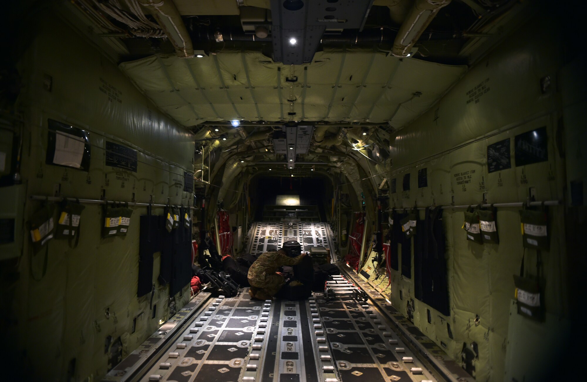 An Airman from a 435th Security Forces Squadron fly-away security team prepares his gear on a C-130-J Super Hercules prior to a mission in support of the Ebola virus epidemic, Oct. 7, 2014, at Ramstein Air Base, Germany. As the Ebola outbreak becomes a potential global threat, U.S. Africa Command is working in support of the U.S. Agency for International Development, the lead federal agency (LFA), as part of a comprehensive U.S. Government effort to respond to and contain the outbreak of the Ebola virus in West Africa as quickly as possible.  This was the first C-130J Super Hercules flight launched from Ramstein to Monrovia, Liberia in support of Operation UNITED ASSISTANCE. (U.S. Air Force photo by/Staff Sgt. Sara Keller)