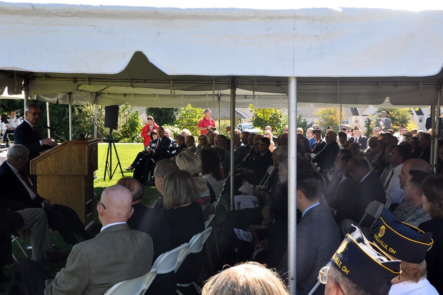 YOUNGSTOWN, Ohio – Air Force Reserve 910th Airlift Wing commander, Col. James Dignan, 910th Force Support Squadron Maj. Dustin Pawlak, based at near Youngstown Air Reserve Station (YARS), Ohio, (both lower right) listen as Youngstown State University (YSU) president James Tressel speaks during the ribbon cutting ceremony of a new, $1.3 million Veterans Resource Center on the YSU campus here, Sept. 26, 2014. The new center is designed to expand and enhance services for military veterans and active military making the transition to student life at YSU. Servicemembers assigned to YARS who are also students or alumni of YSU are encouraged to utilize the new facility. U.S. Air Force photo by Master Sgt. Bob Barko Jr.