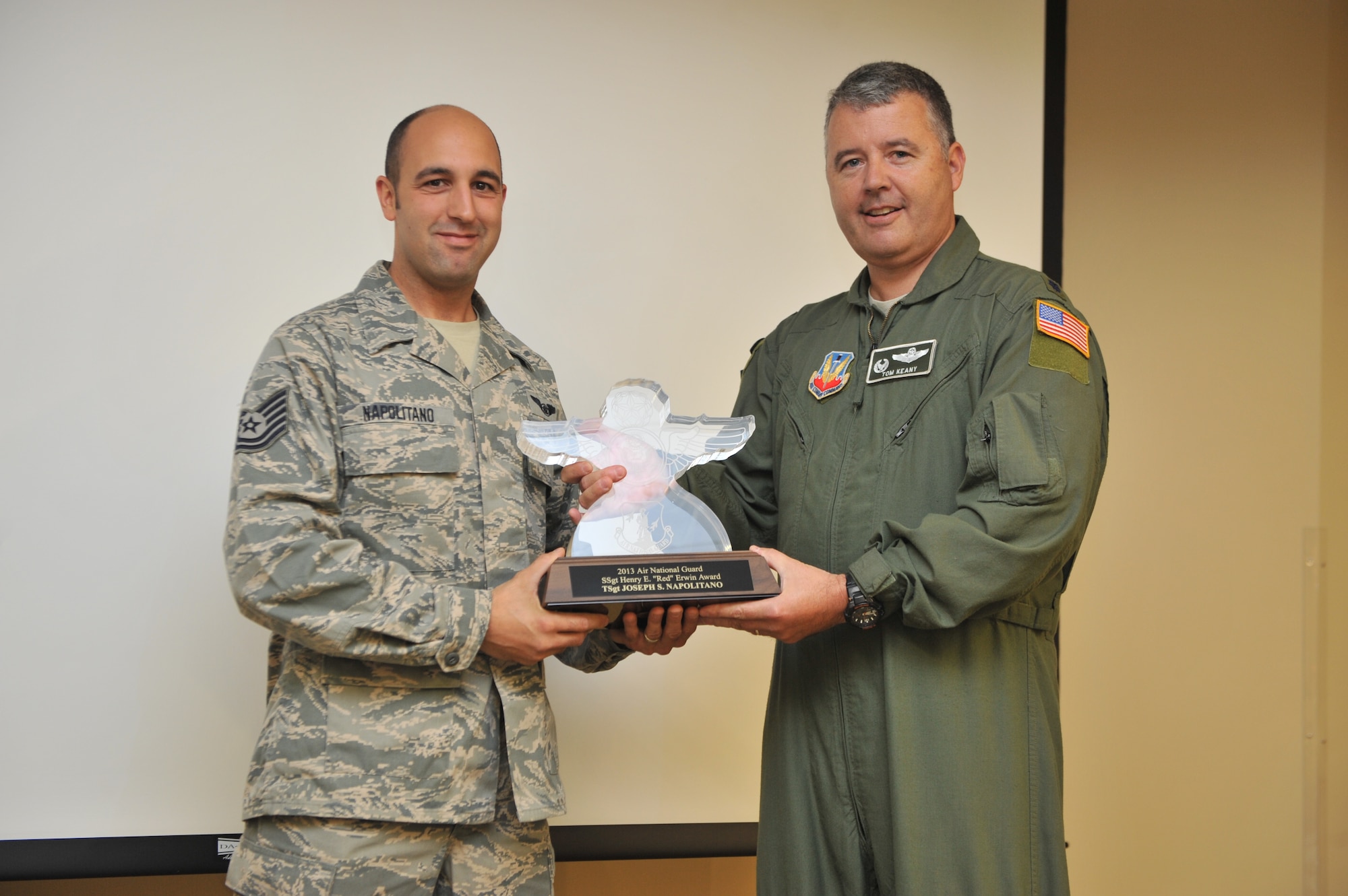 WESTHAMPTON BEACH, NY – The 106th Rescue Wing celebrated Tech Sergeant Joseph S Napolitano’s recent awarding of the Henry E. Erwin Outstanding Enlisted Aircrew Member of the Year Award with a surprise ceremony during the October UTA drill. Napolitano , an airmen with the 101s Rescue Squadron, was recognized for his outstanding service in a ceremony attended by his fellow squadron members, base commander Col Thomas J Owens II, Command Chief MSgt Diana Manno, and his wife Dusty and children, Jordan and Chloe.  

