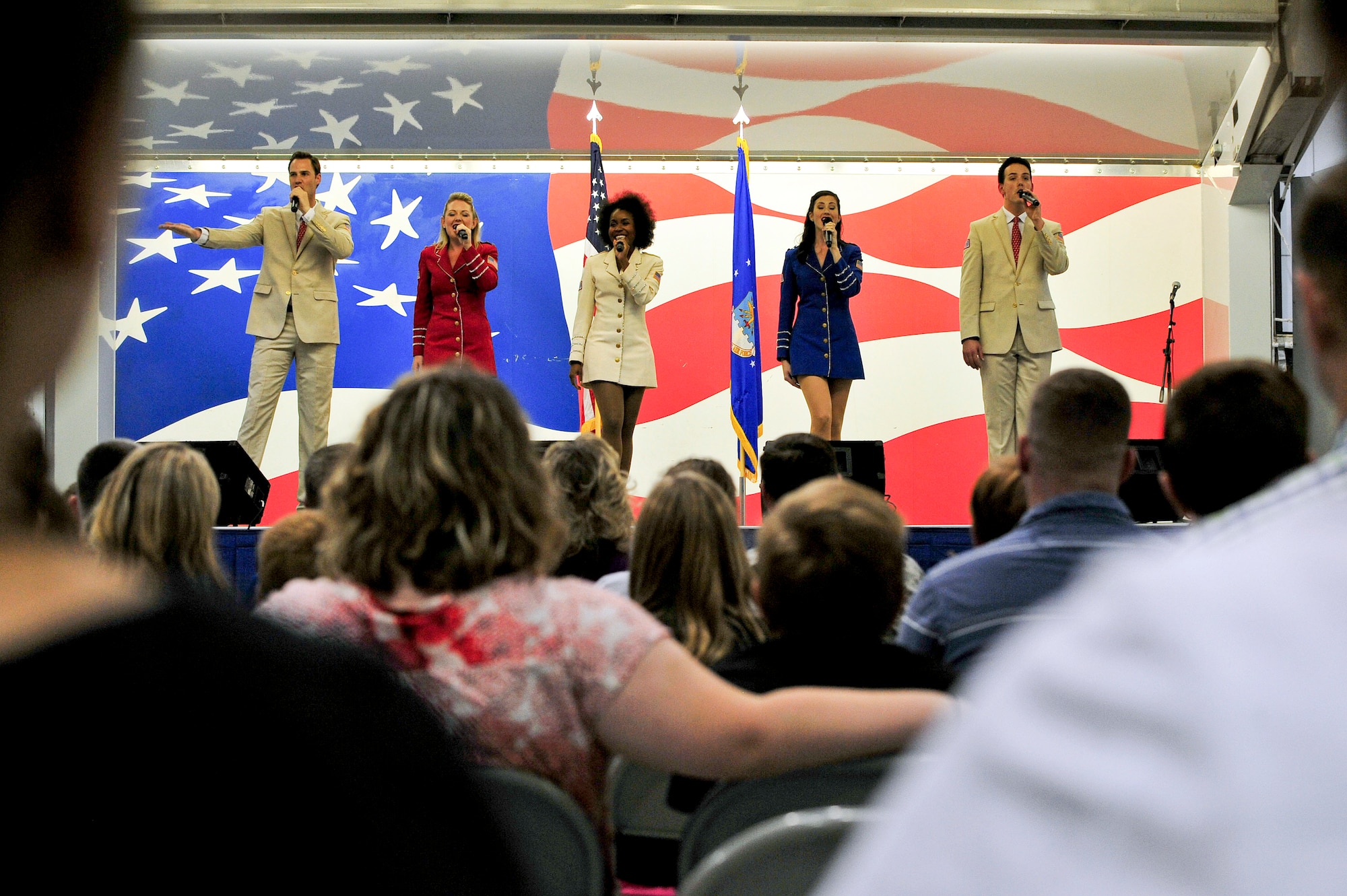 Performers from the United Service Organizations Show Troupe sing during a performance at Seymour Johnson Air Force Base, North Carolina, Oct. 3. The Show Troupe, made up of five singers and a support team, provided an hour-long set for members of Team Seymour. They annually perform musical entertainment for more than 600,000 service members and families across the globe. (U.S. Air Force photo/Senior Airman John Nieves Camacho)